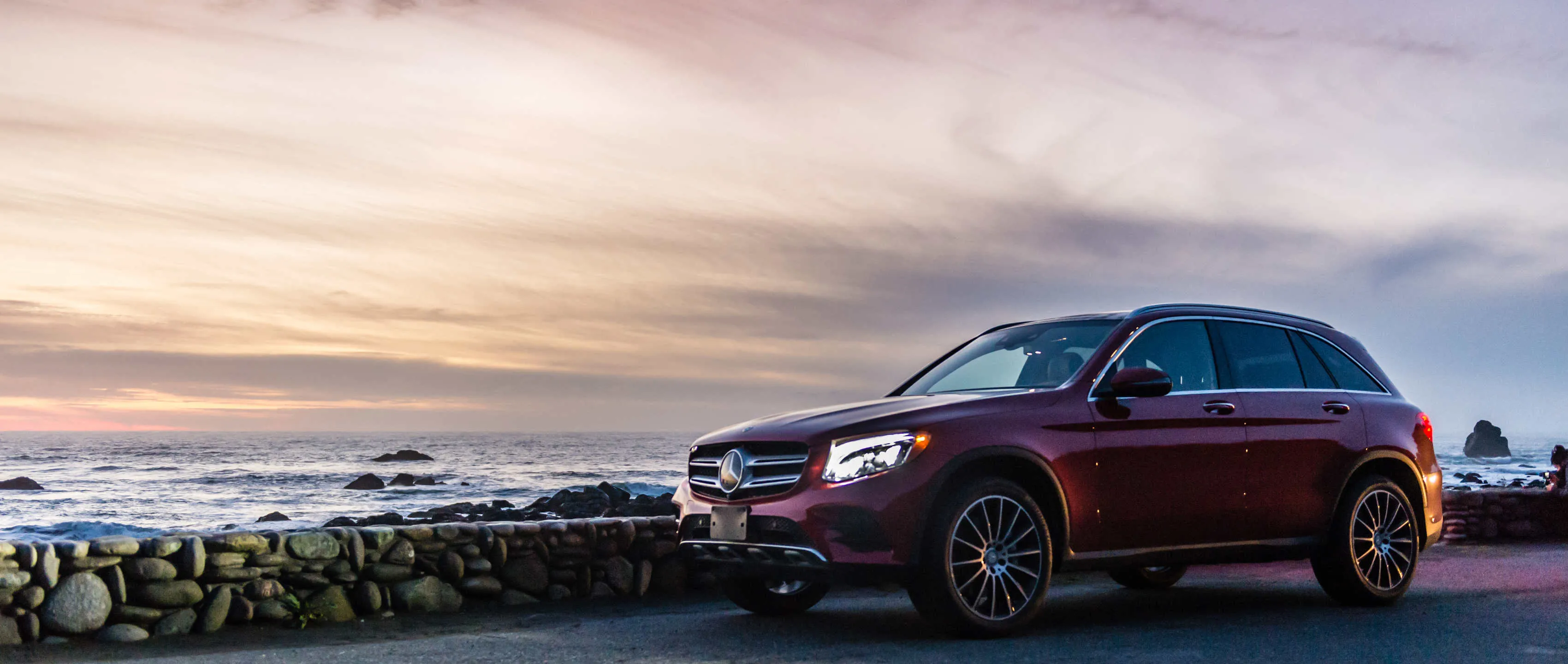 Mercedes Benz SUV at Sunset by the Ocean Shoreline Wallpaper