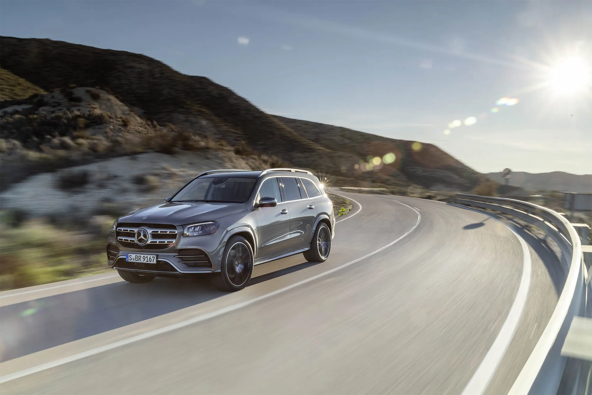 Mercedes Benz SUV Driving on Curvy Mountain Road Wallpaper
