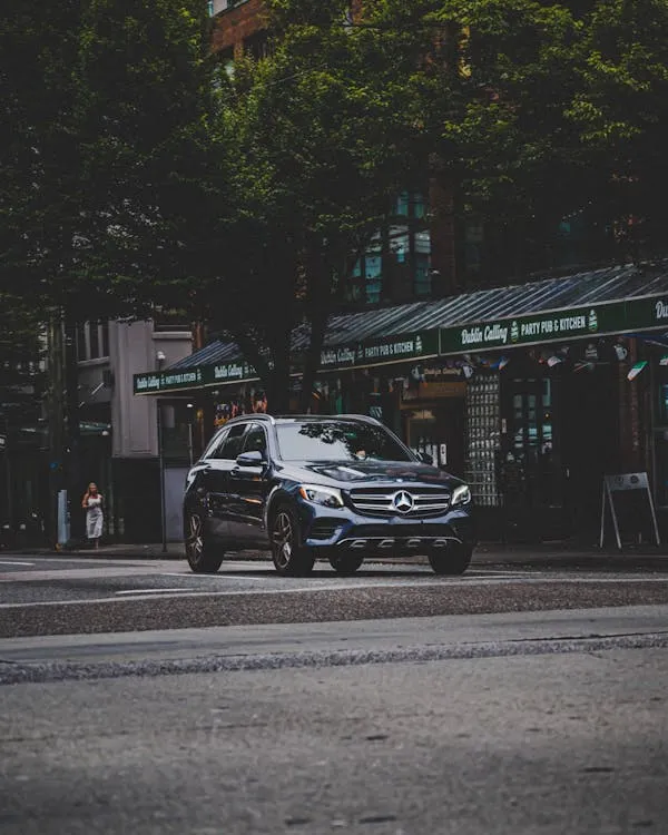 Mercedes Benz SUV Driving Through Urban City Streets