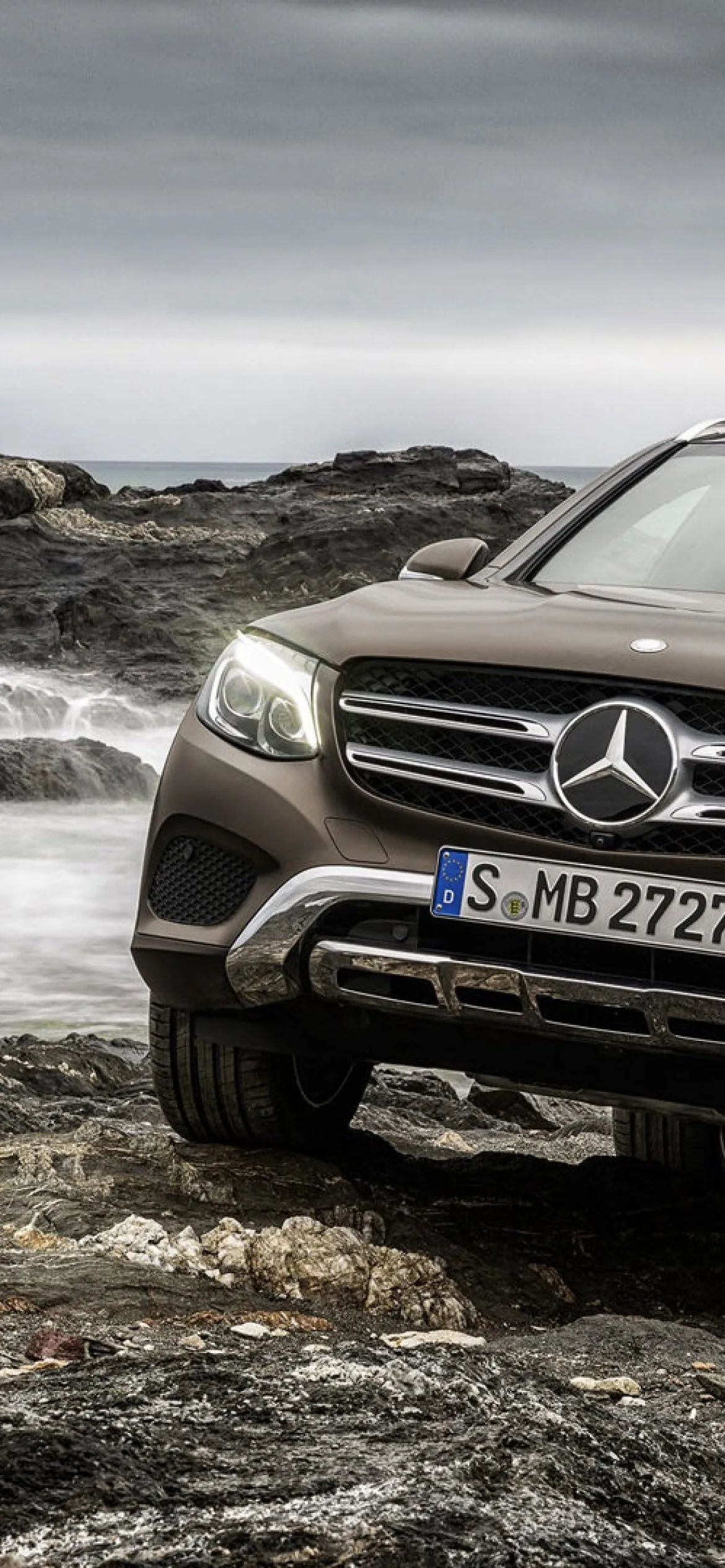 Mercedes Benz SUV Front Side View on Rocky Coastal Shore