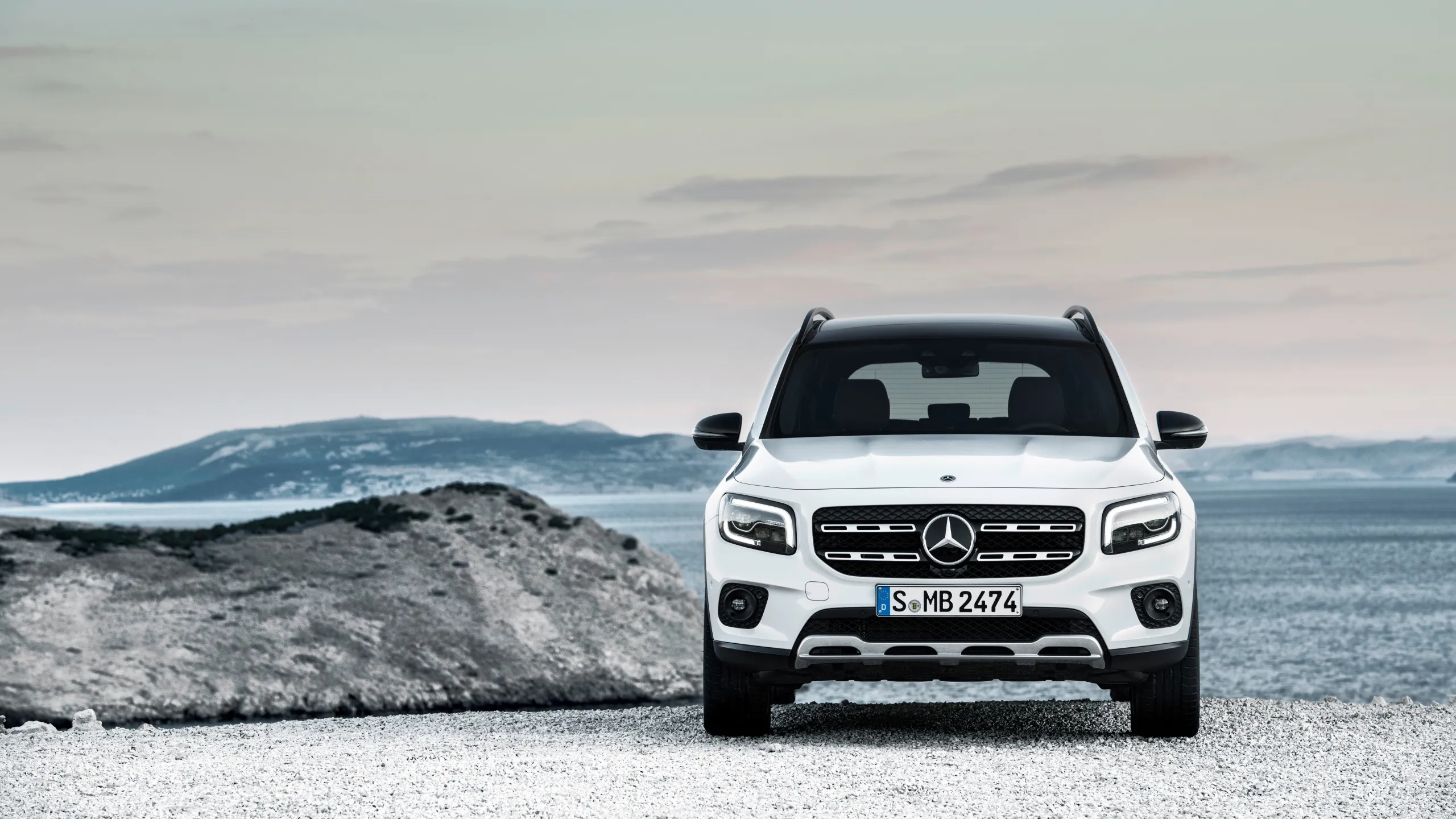 Mercedes Benz SUV on Rugged Landscape with Blue Sky