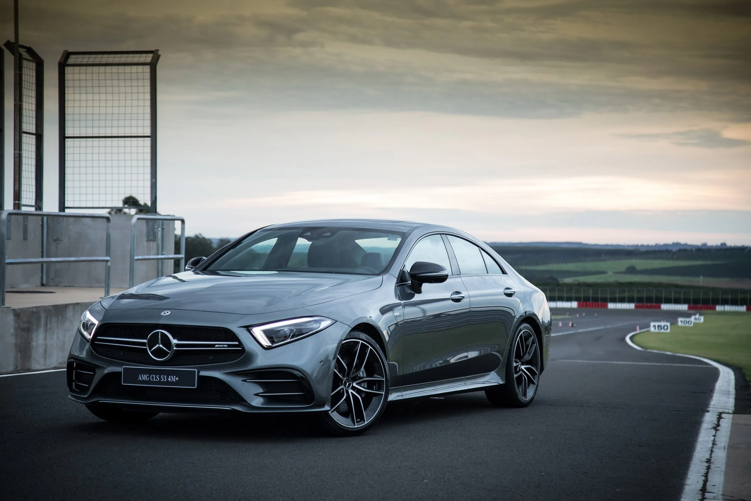 Mercedes CLS Model Driving on Track Near Racing Pit Lane