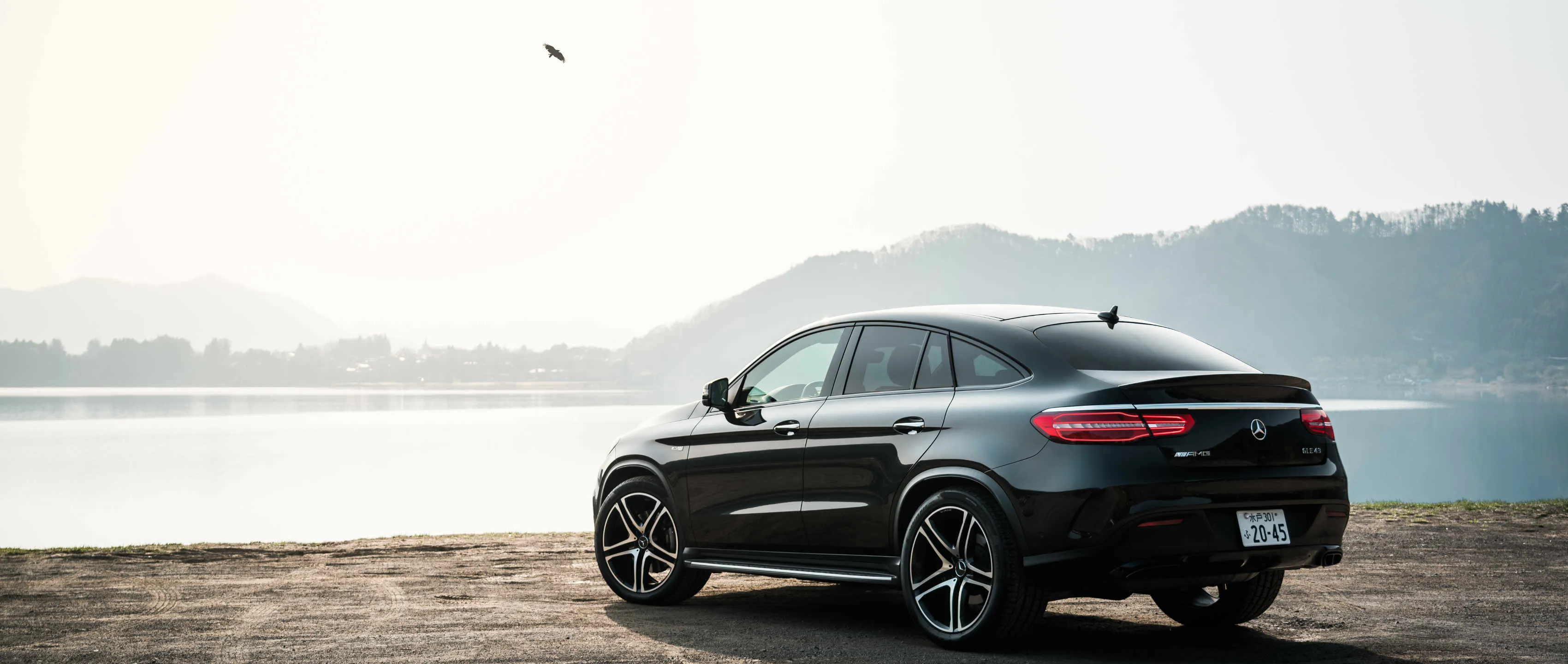 Mercedes Convertible Driving Along Foggy River Wallpaper