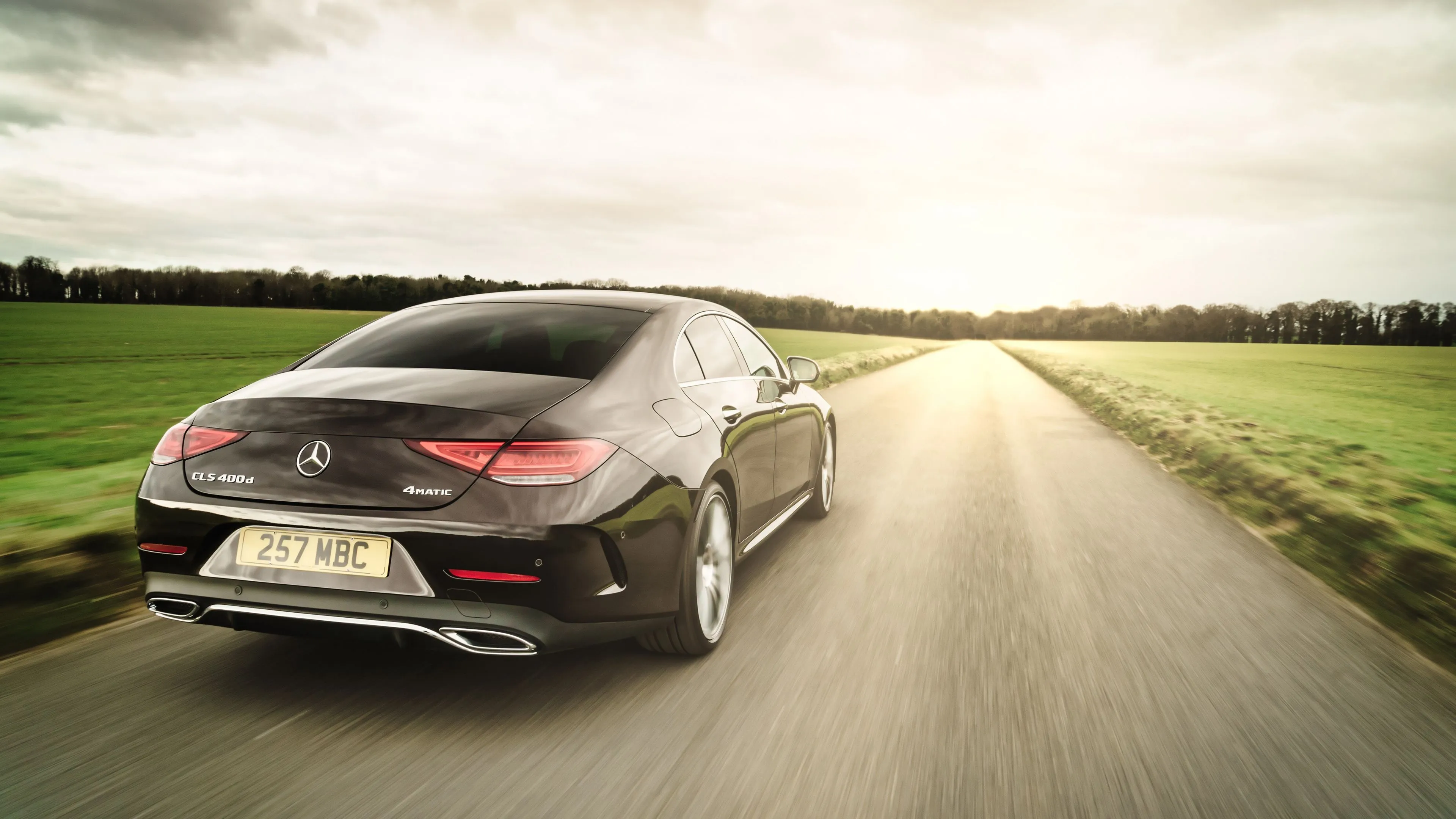 Mercedes Coupe Driving Alone on Rural Highway Wallpaper
