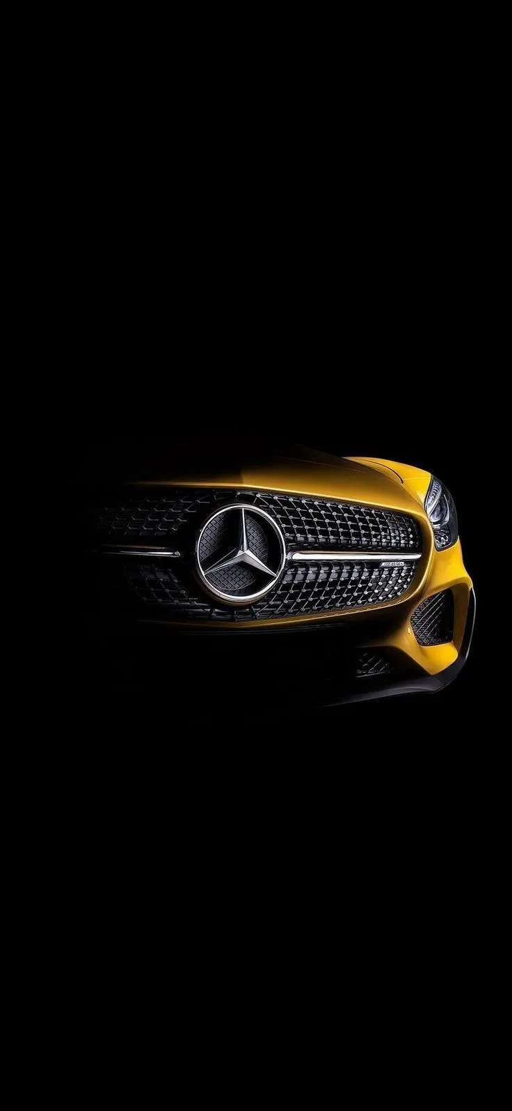 Mercedes Emblem Illuminated in Dark with Yellow Lighting