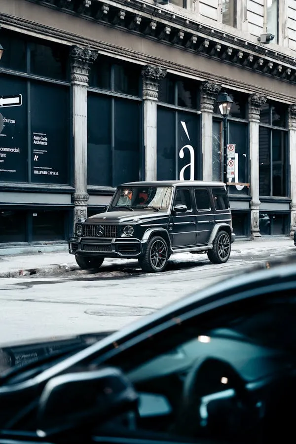 Mercedes G Class driving through upscale city street