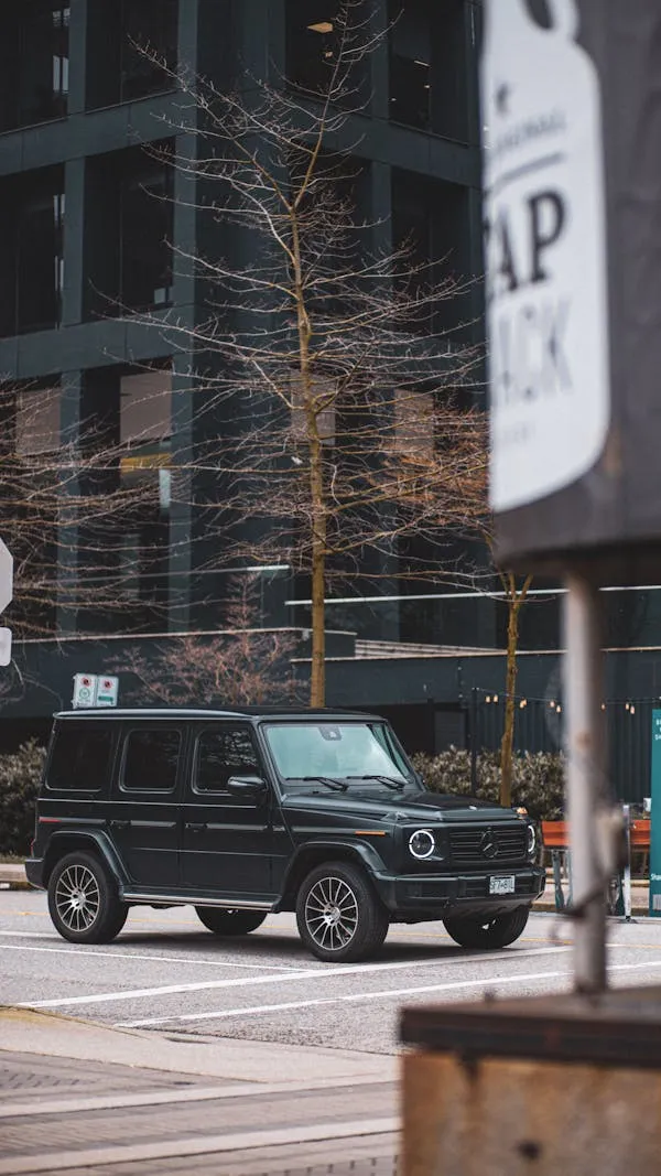 Mercedes G Wagon Parked by Signpost in Urban Area image