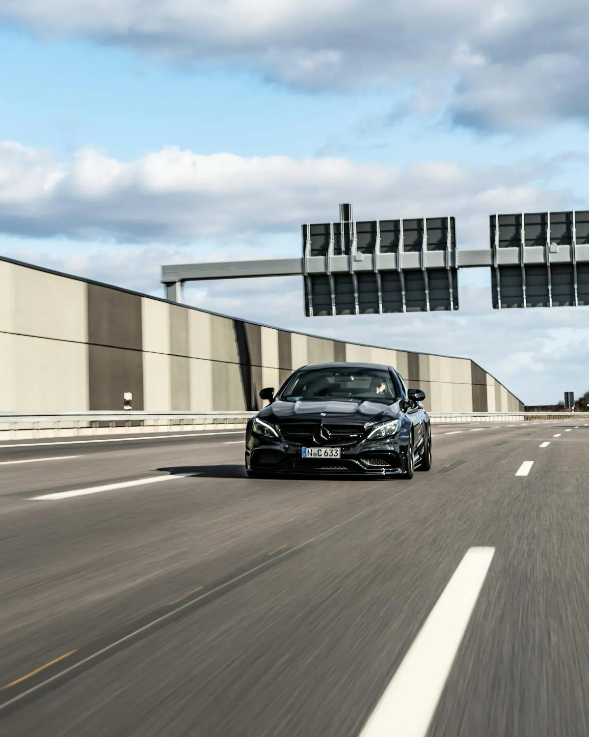 Mercedes Sedan Driving Fast on Modern Highway Bridge