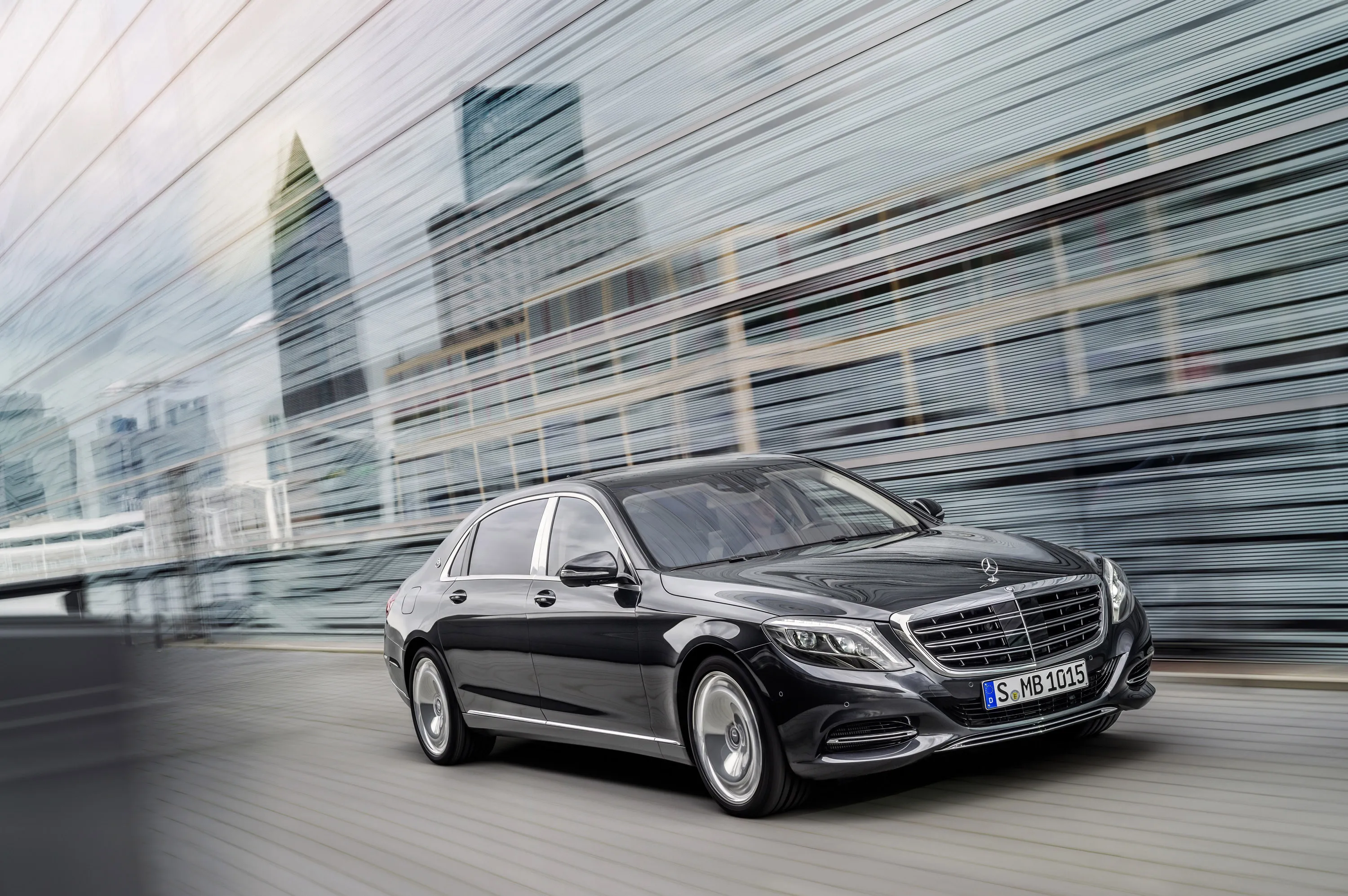 Mercedes Sedan Driving Past Modern City Glass Towers