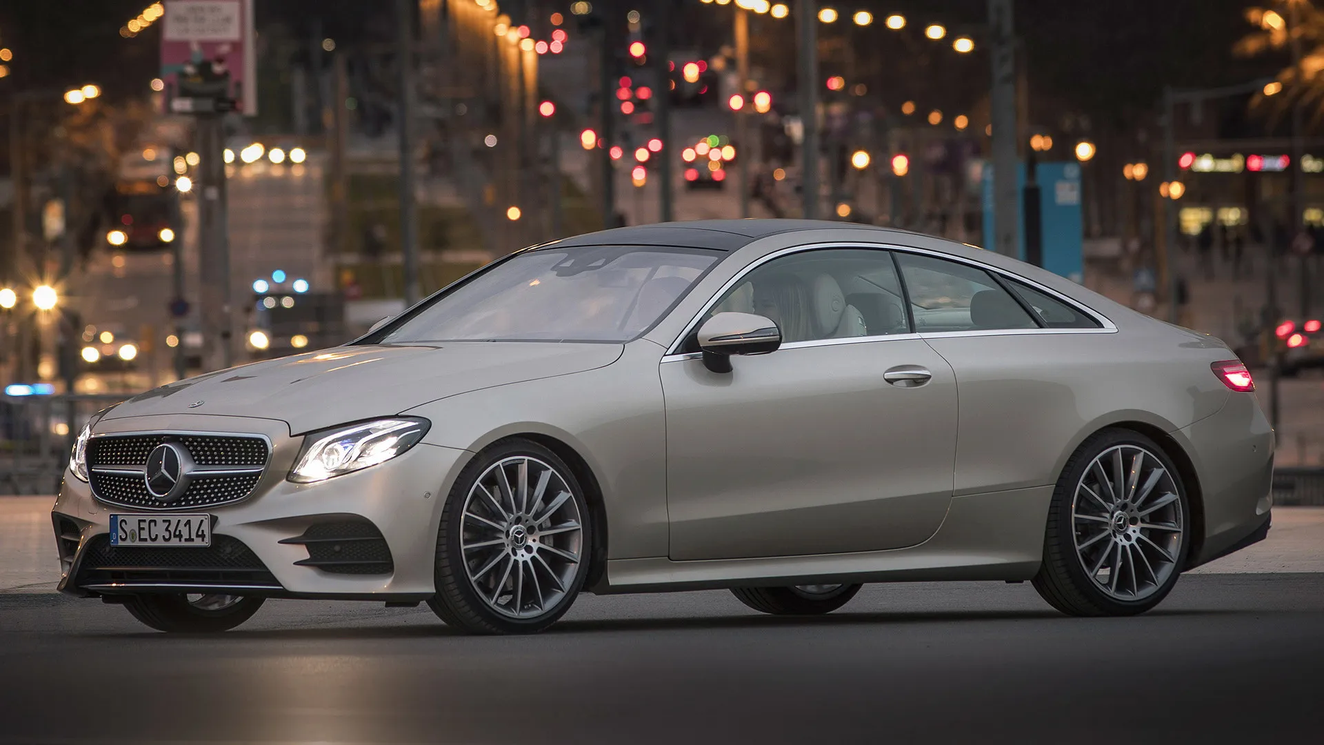 Mercedes Sedan Driving Through City Lights at Night 4K image