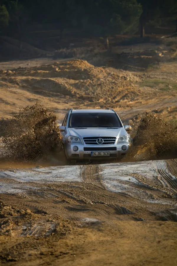 Mercedes SUV off roading through rugged mountain terrain
