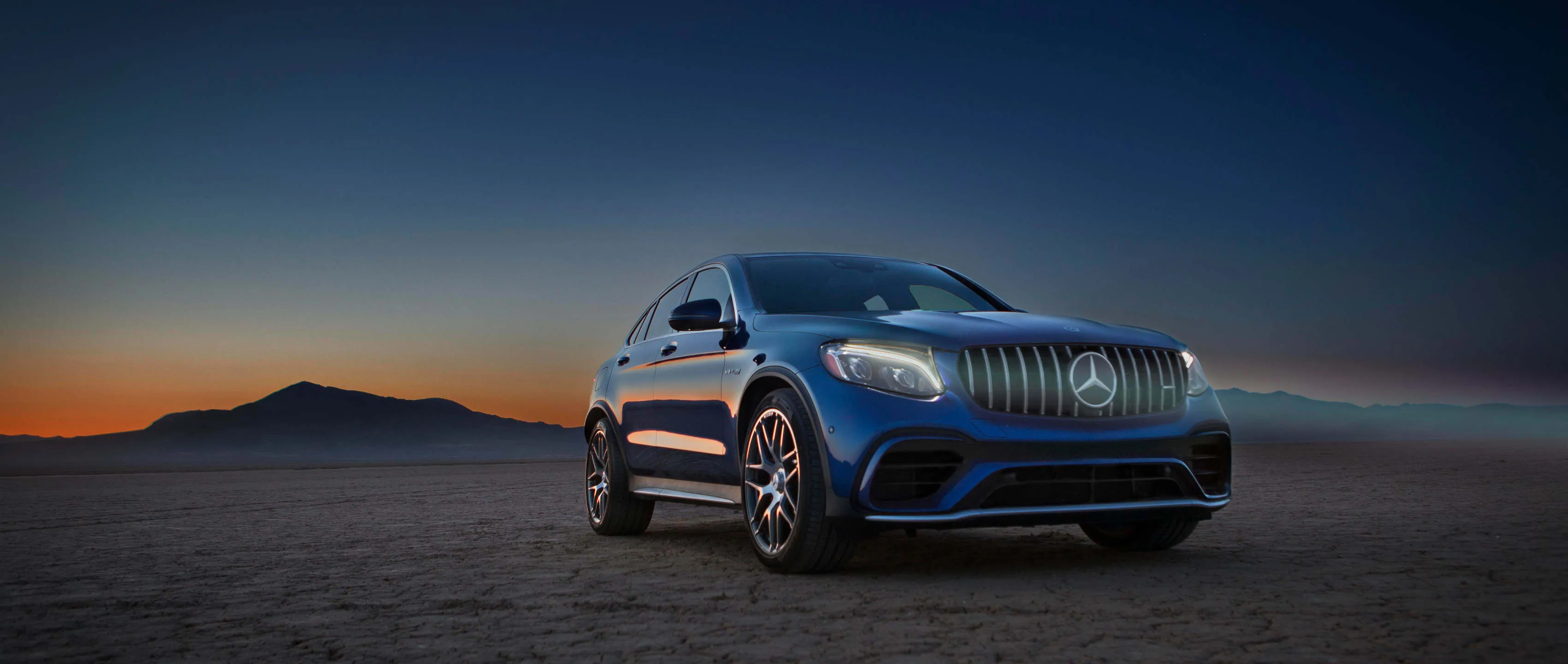 Mercedes SUV Parked in Desert at Sunset Hour Wallpaper