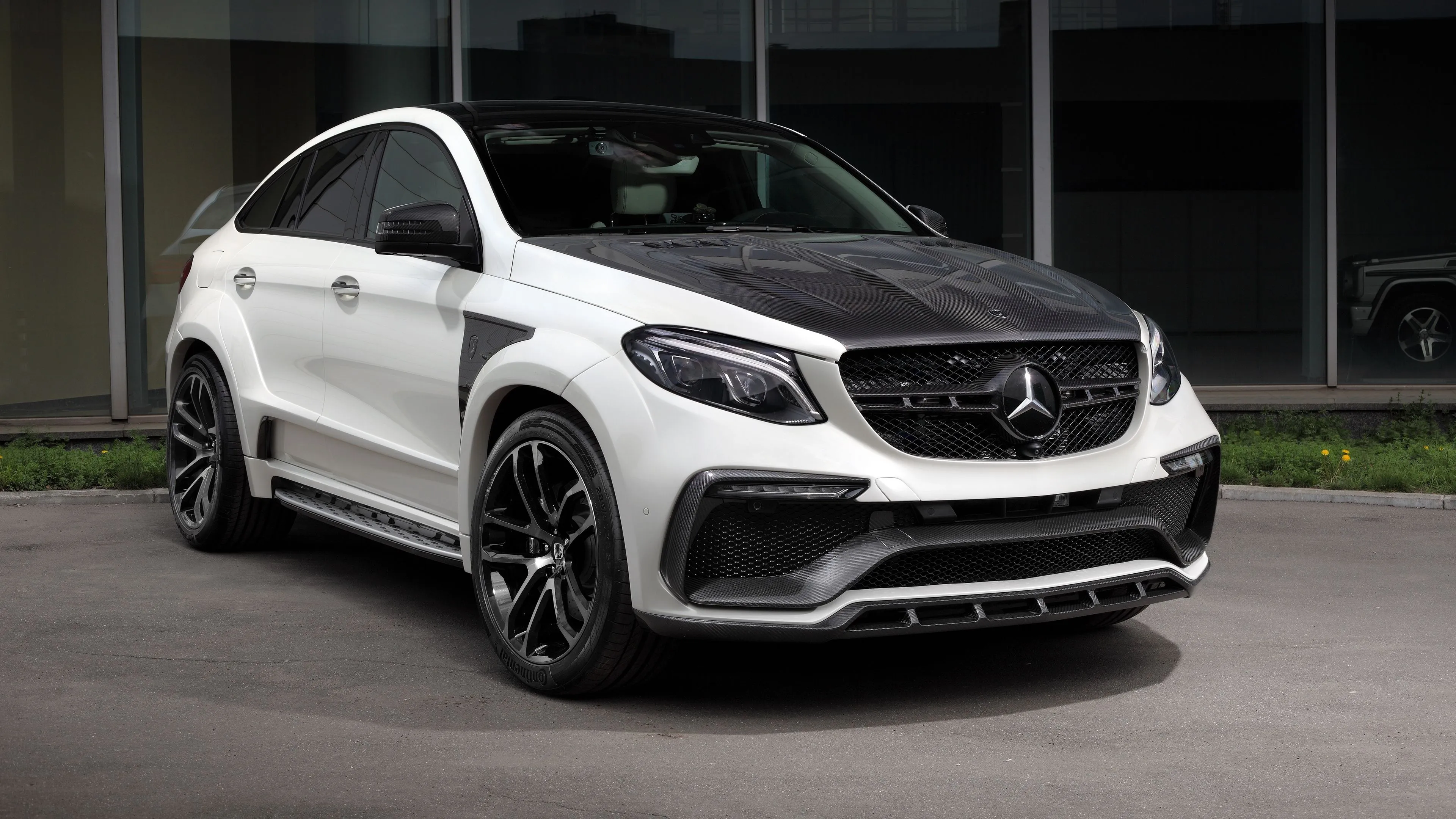 Mercedes SUV Parked Outside a Glass Modern Building
