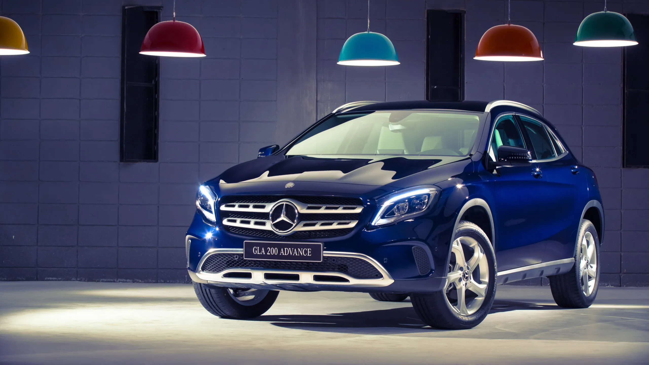 Mercedes SUV Parked Under Indoor Colorful Showroom Lights