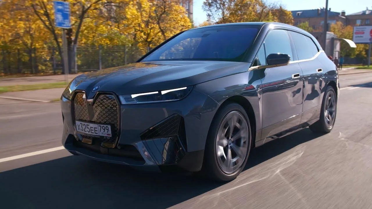 Modern Bmw Suv Driving Through Autumn City Street Wallpaper