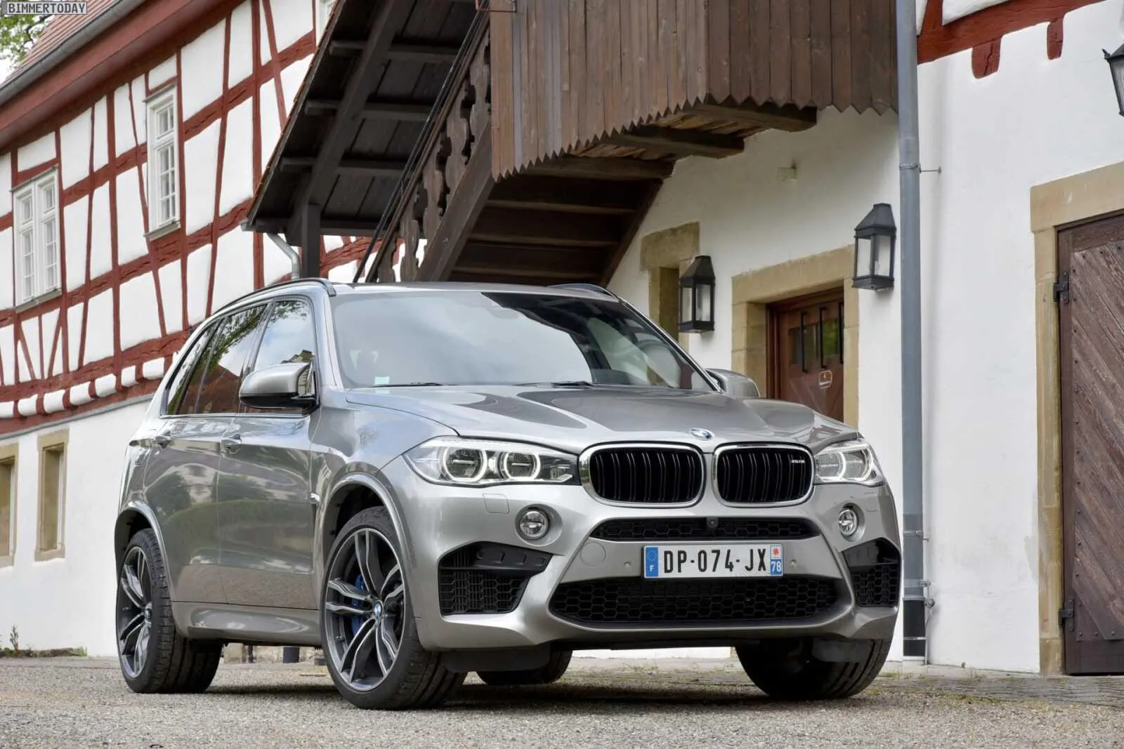 Modern Bmw Suv Parked in Front of a House and Building