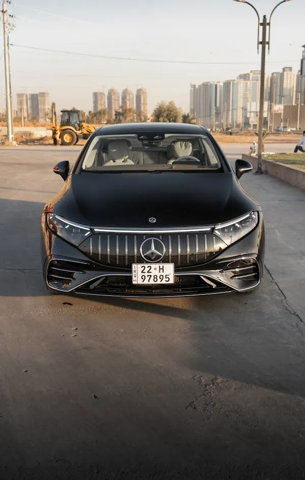 Modern Mercedes Benz Car Driving on City Street Wallpaper