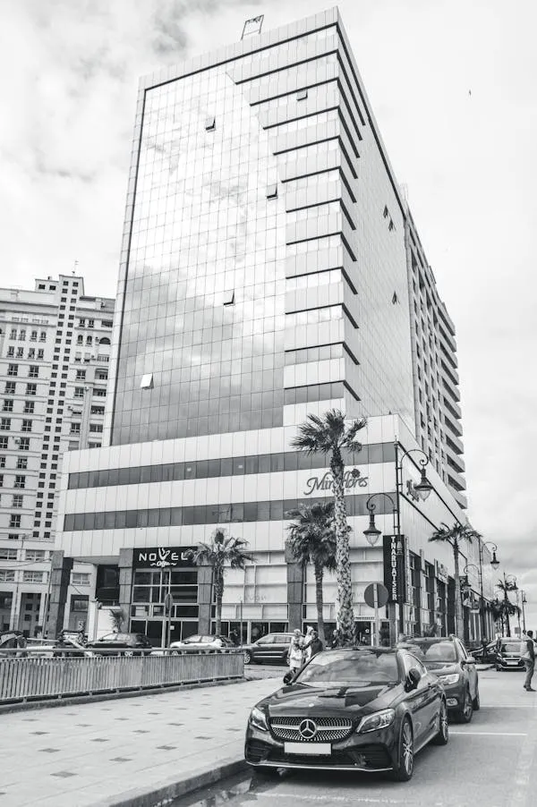 Monochrome Mercedes Driving Through Urban Modern Wallpaper