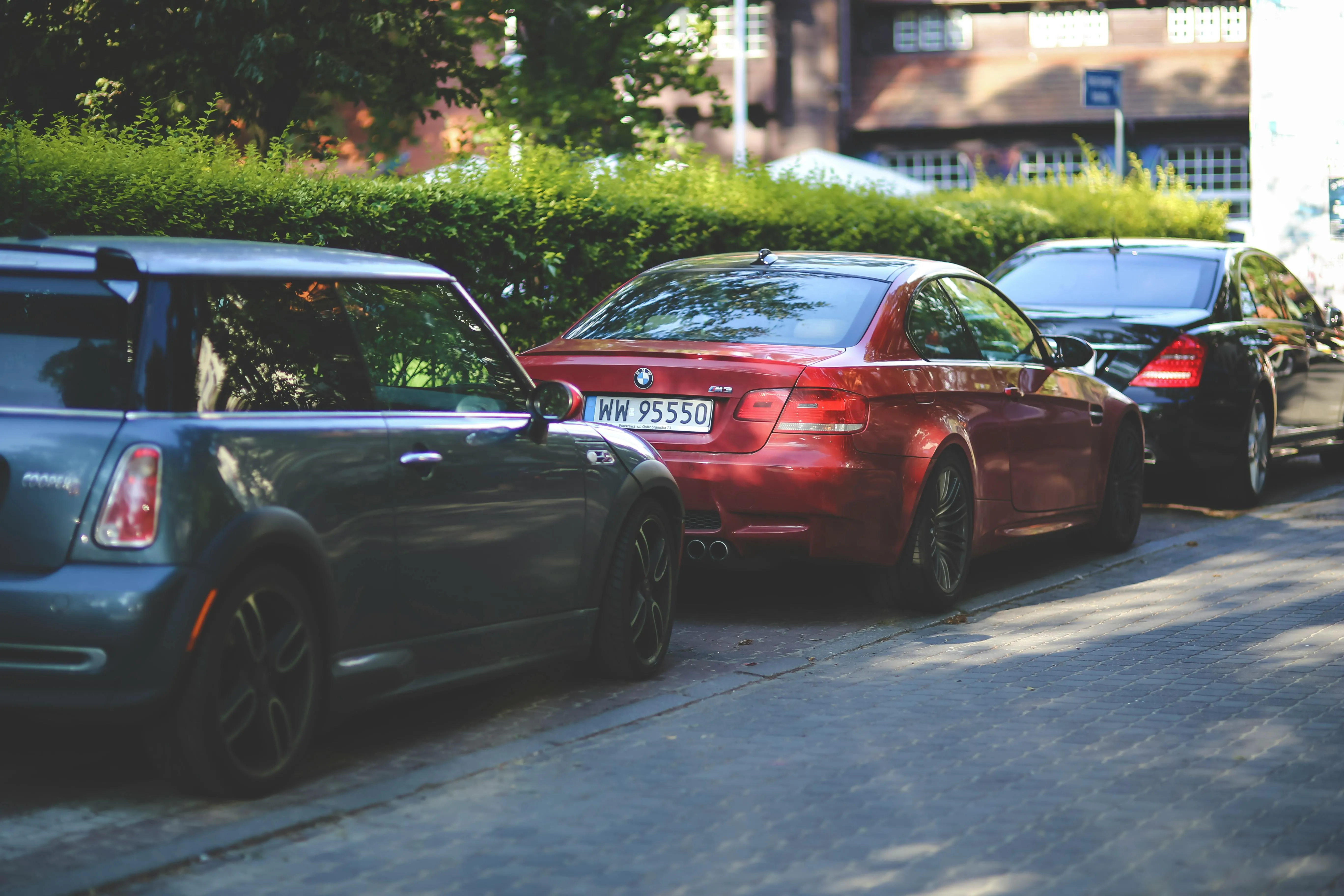 Multiple Bmw Cars Parked on Shaded Street in the City