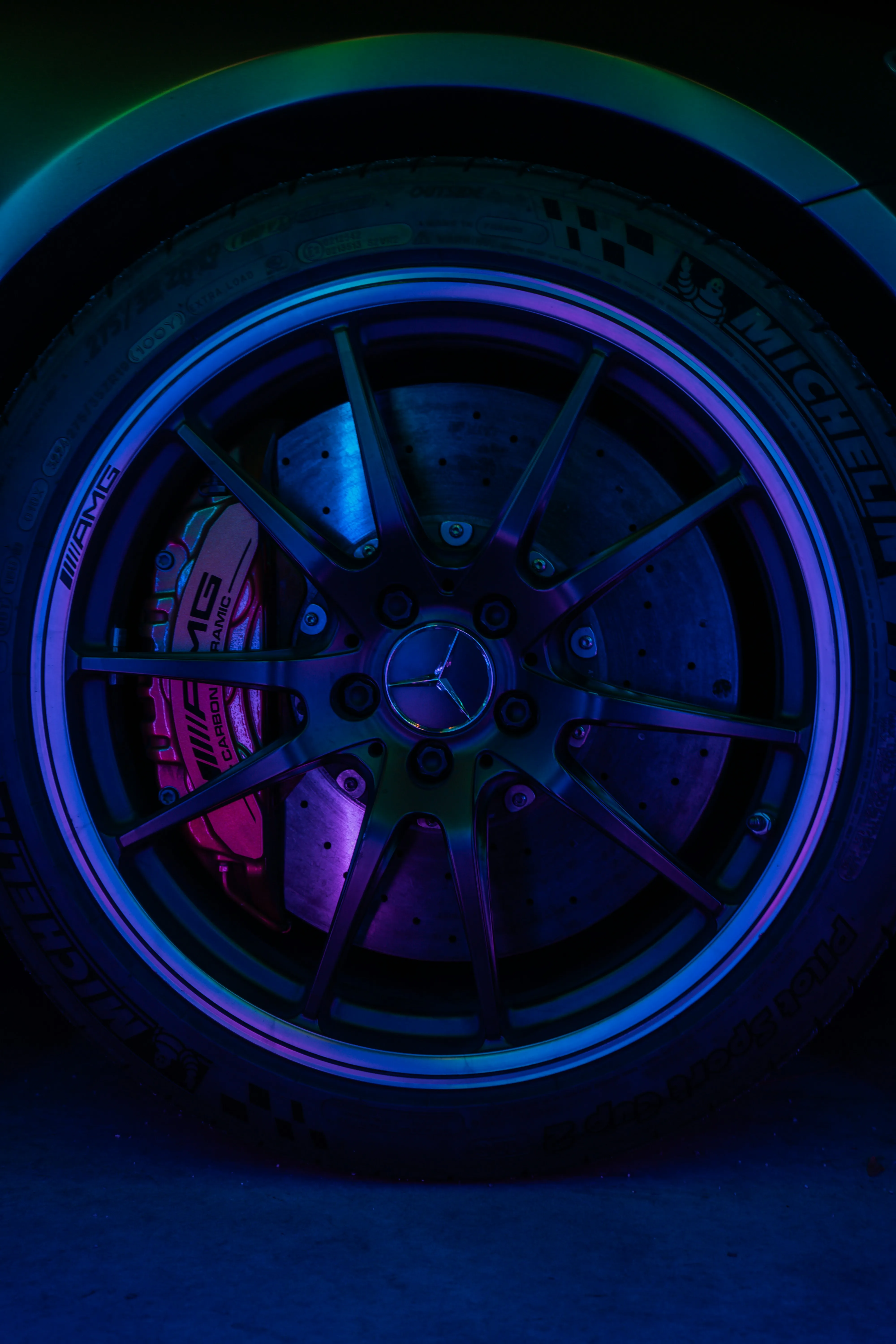 Neon Lit Car Wheel of Mercedes Benz at Night Wallpaper