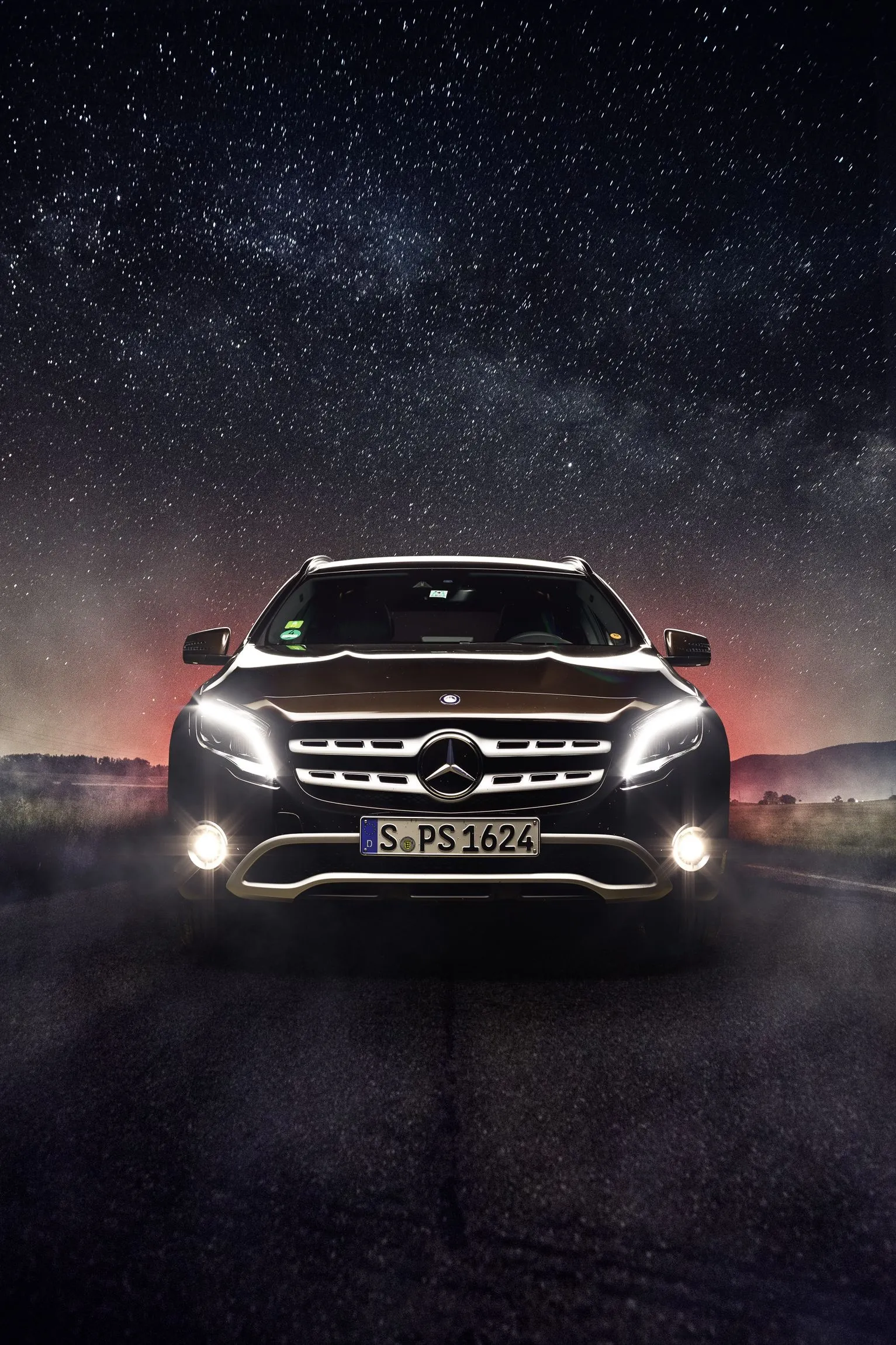 Night Front View of Mercedes with Headlights On Wallpaper