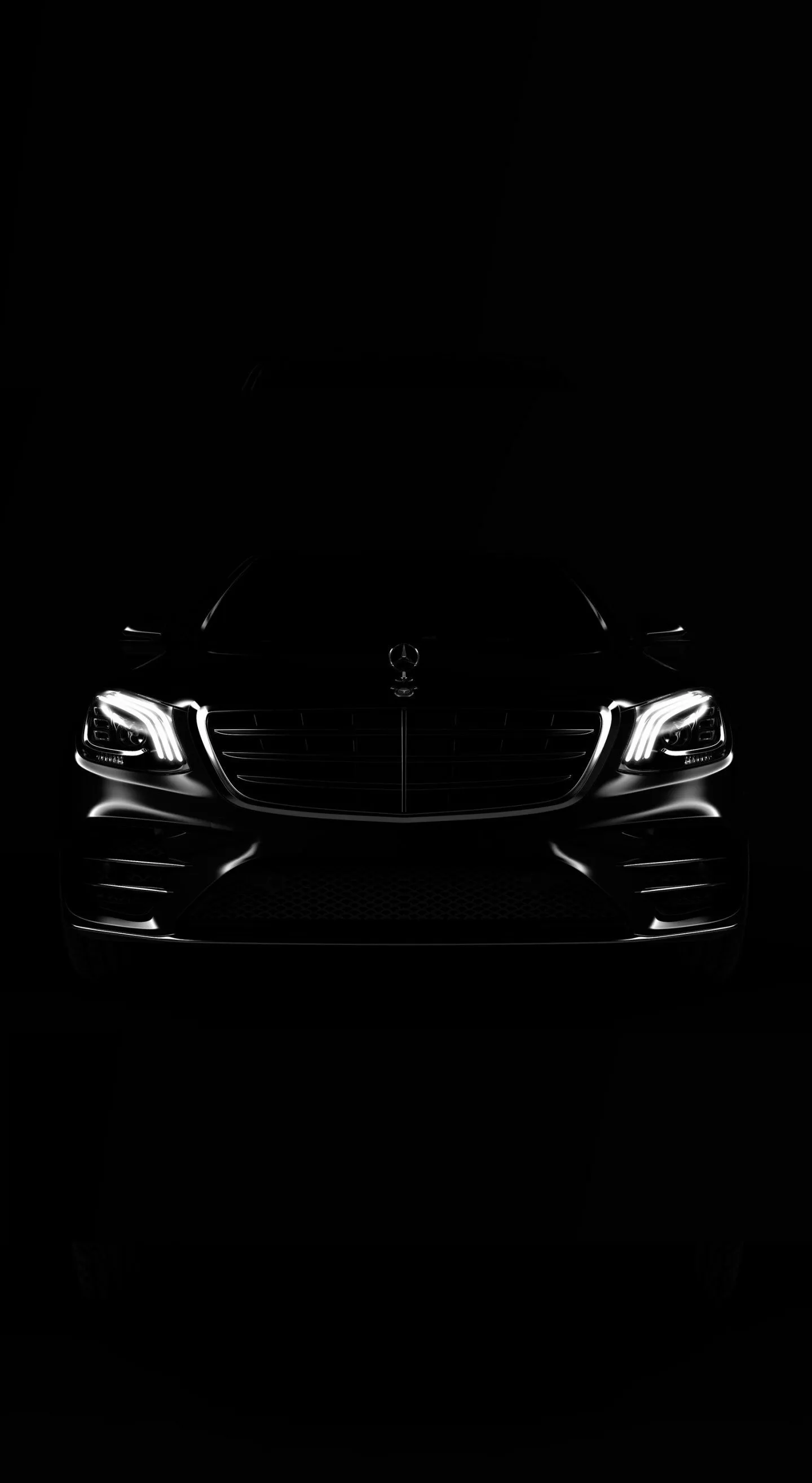 Night shot of Mercedes front grille with headlights on