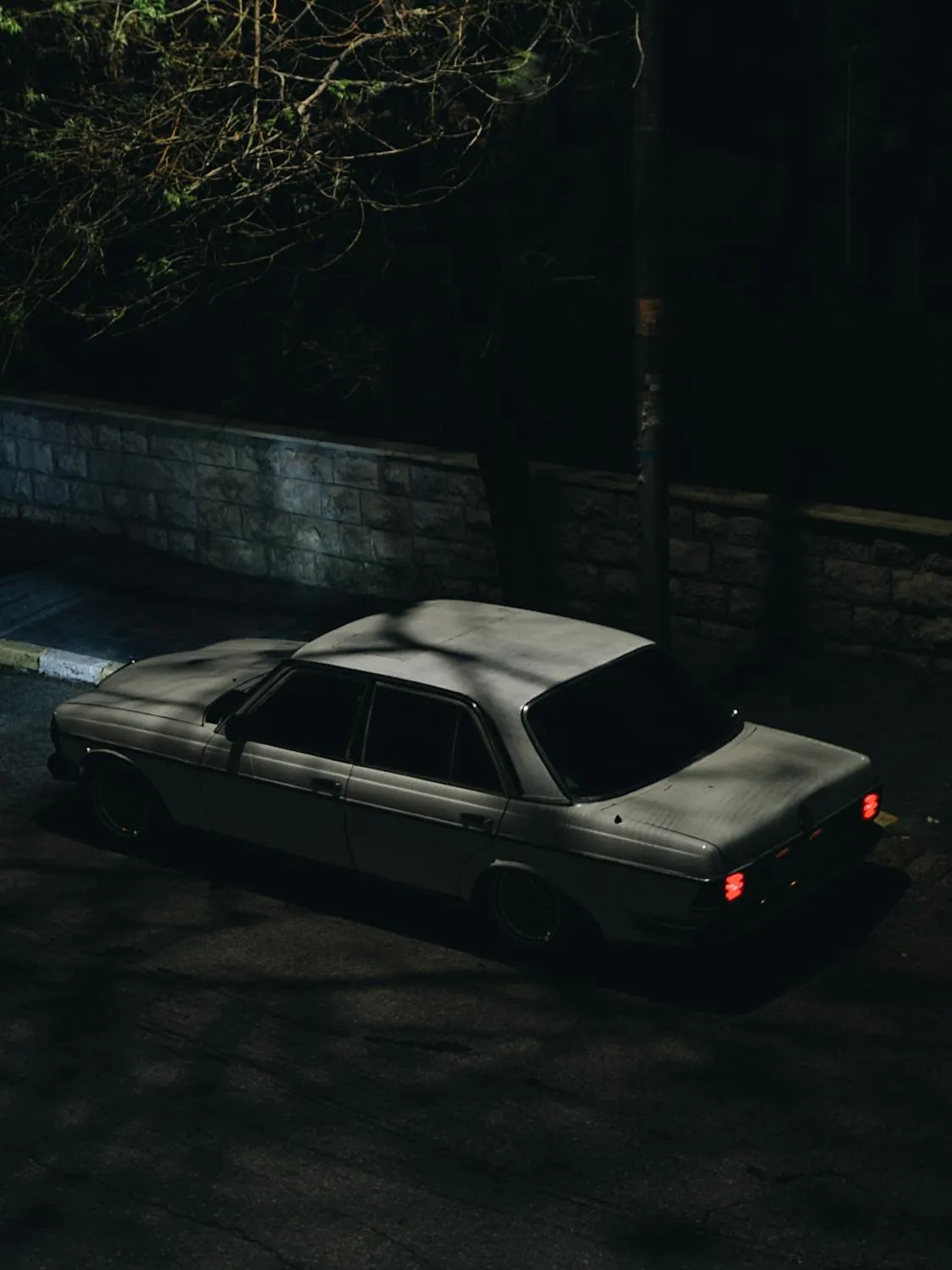Night View of Classic Mercedes Parked Under Streetlight