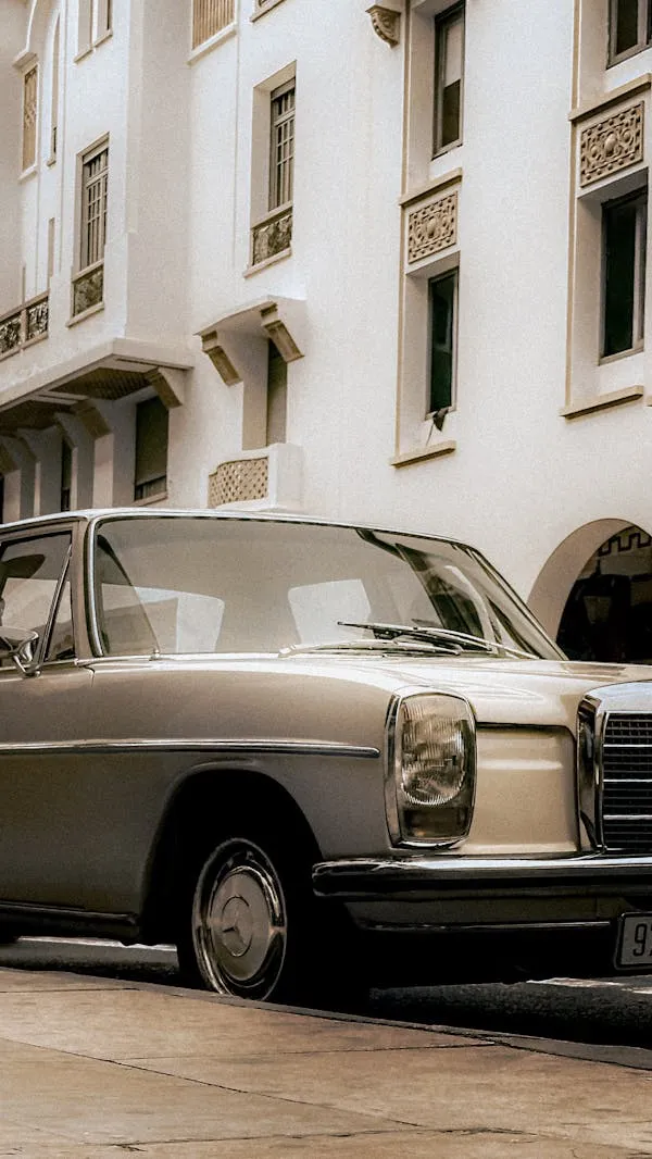 Old Mercedes Benz Parked by White Urban Building Wallpaper