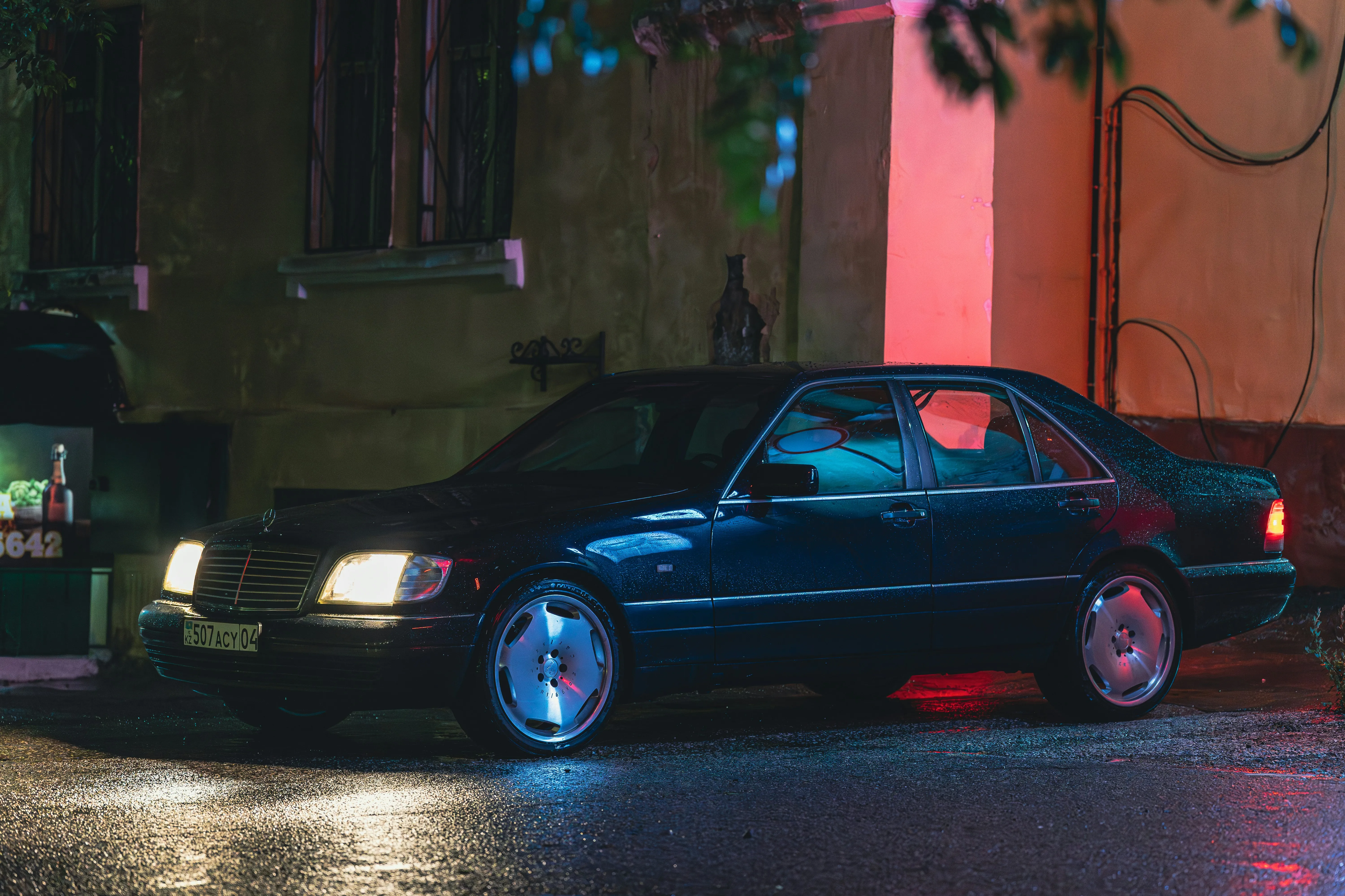 Old Mercedes Benz Parked in Night Street Scene Wallpaper