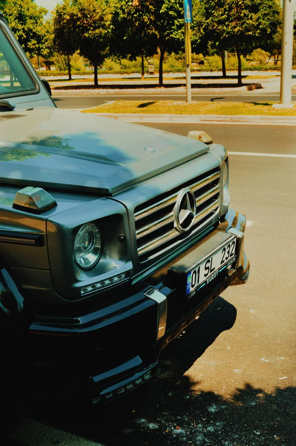 Old Mercedes Benz SUV Parked on City Street in Daylight