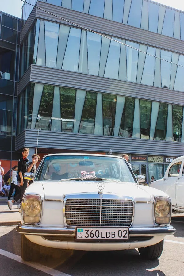 Old Mercedes Car in Front of Modern Office Building