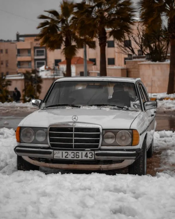 Old Mercedes car partially covered with snow free image 4K
