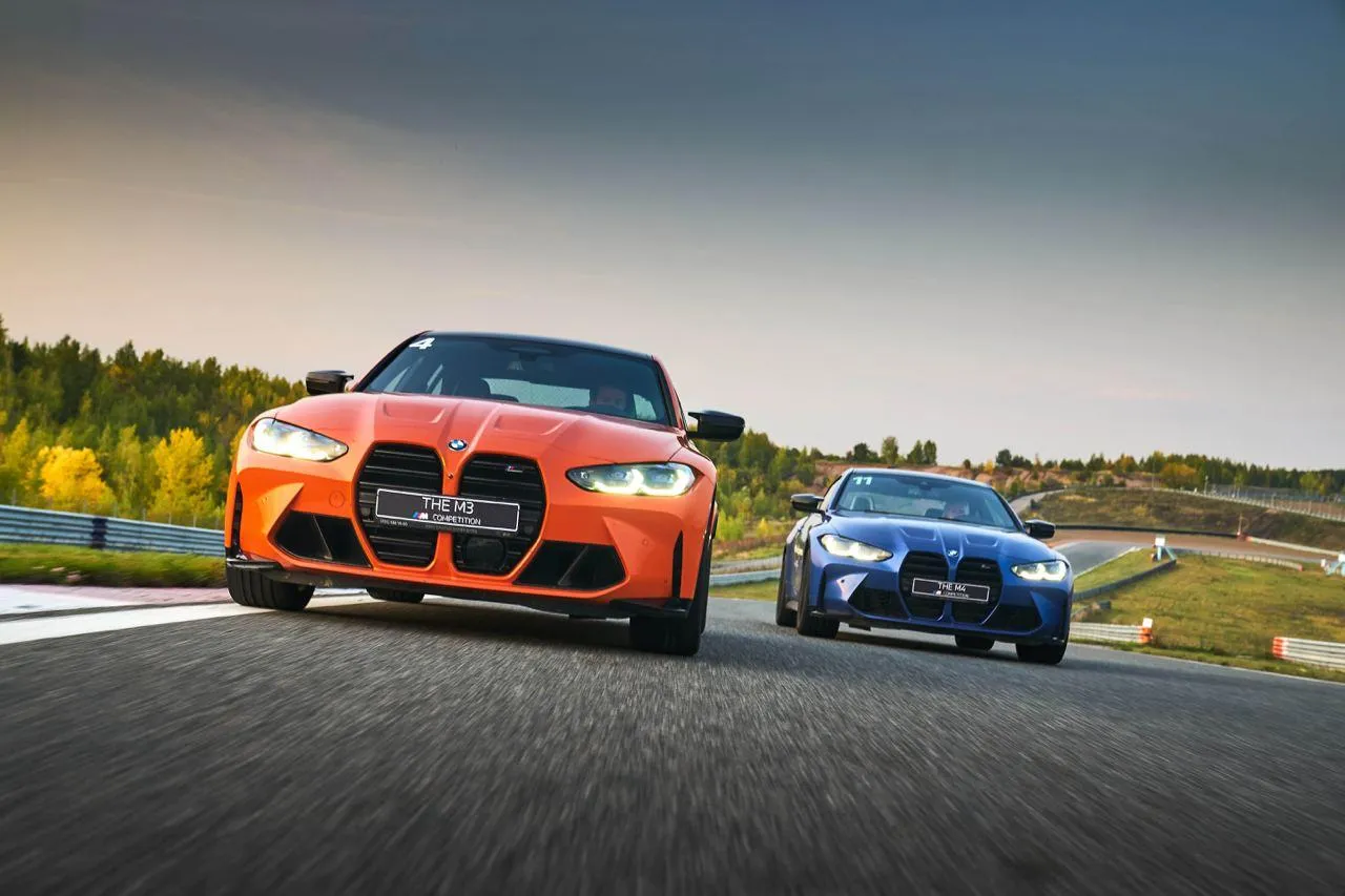 Orange and Blue Bmw Cars Racing on an Open Road Image