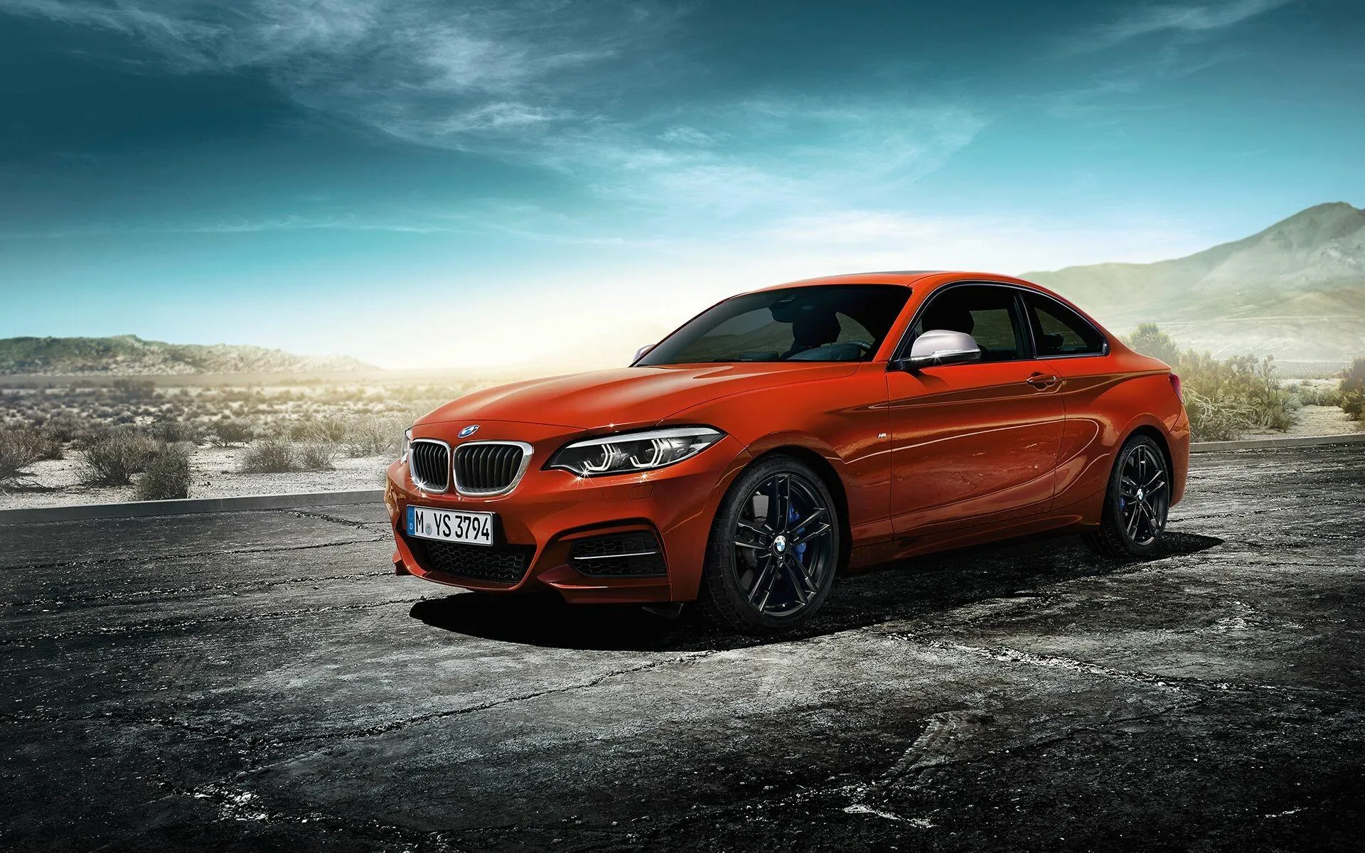 Orange Bmw Coupe Driving Fast on Open Desert Road Image