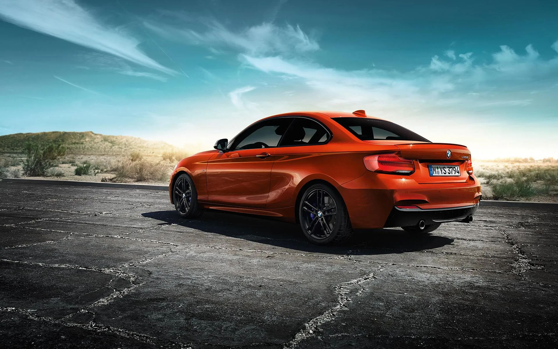 Orange Bmw Coupe Parked on Road Under Bright Blue Sky