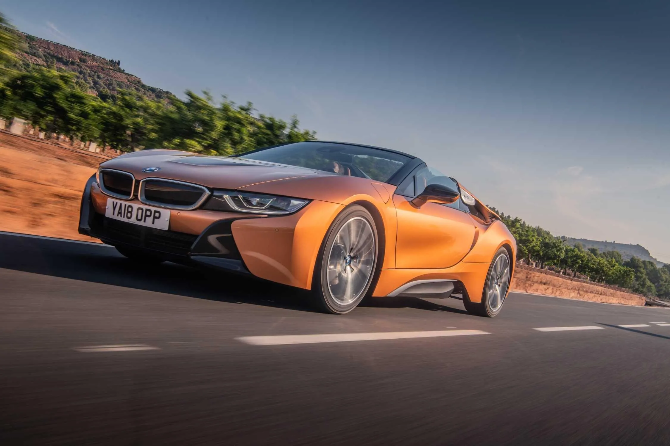 Orange Bmw I8 Driving Fast on Curved Road with Hills