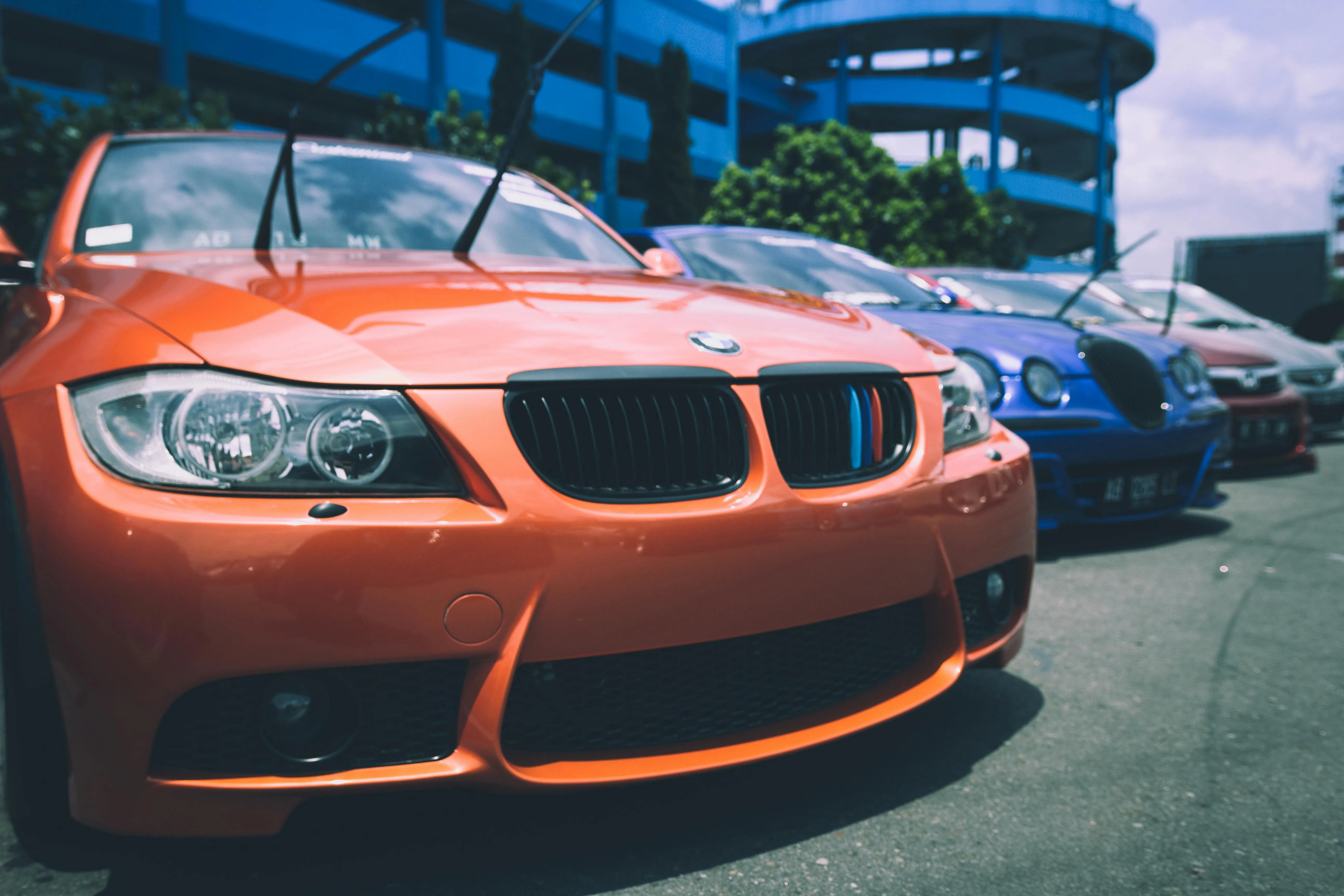 Orange Bmw Sports Car Parked at Auto Show in Daylight