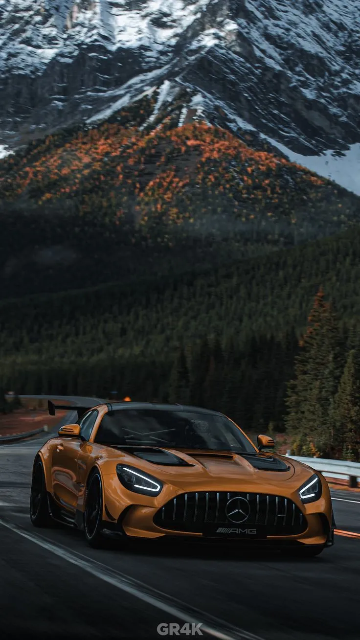 Orange Mercedes Driving Through Scenic Mountain Route