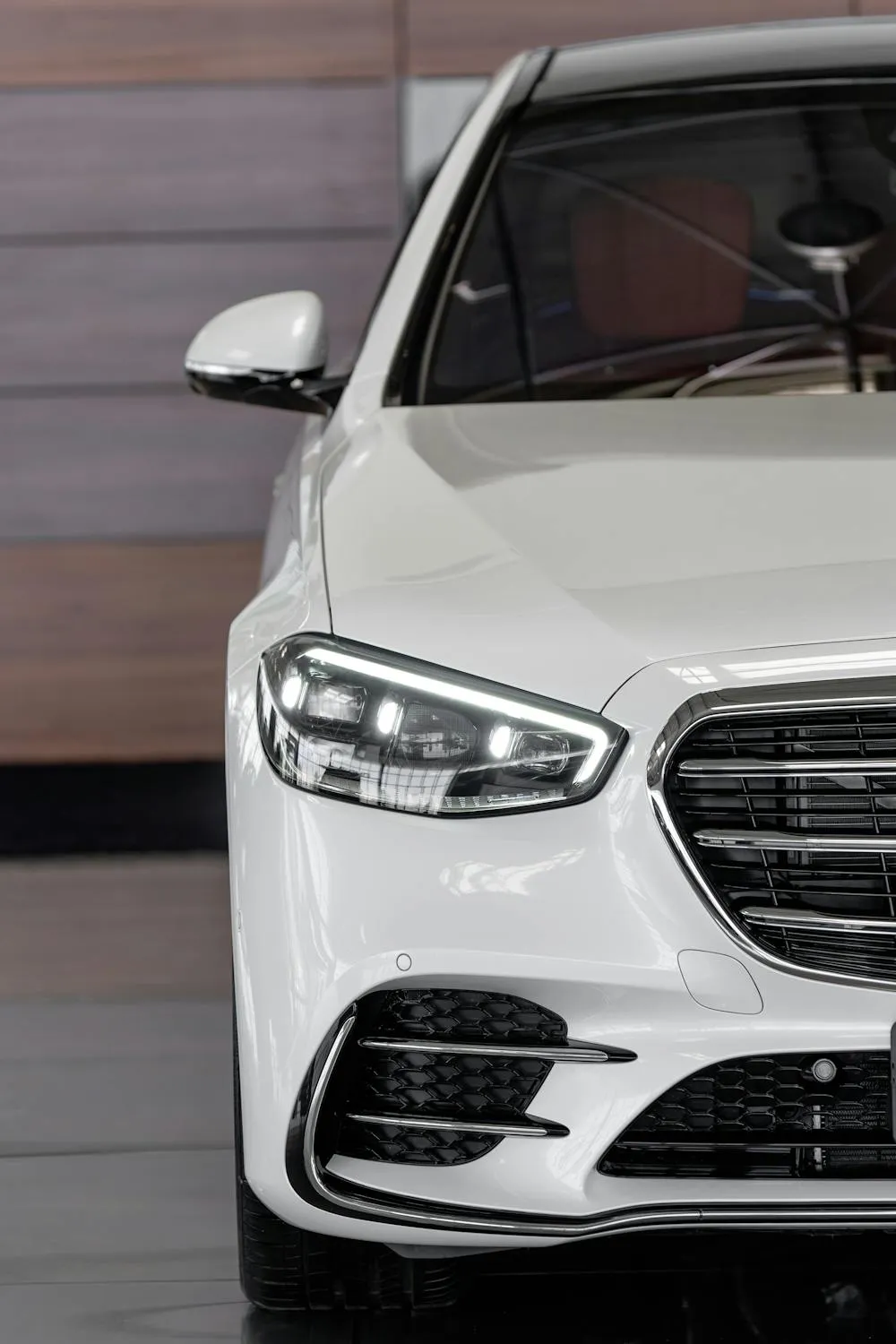Partial Front View of White Mercedes Benz in Garage