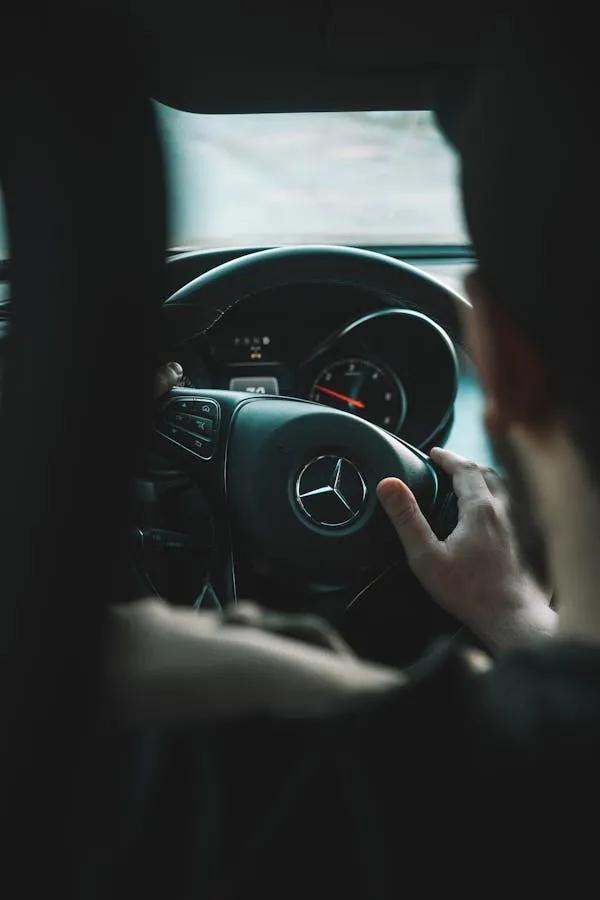 Person Driving Classic Mercedes with Emblem View Wallpaper