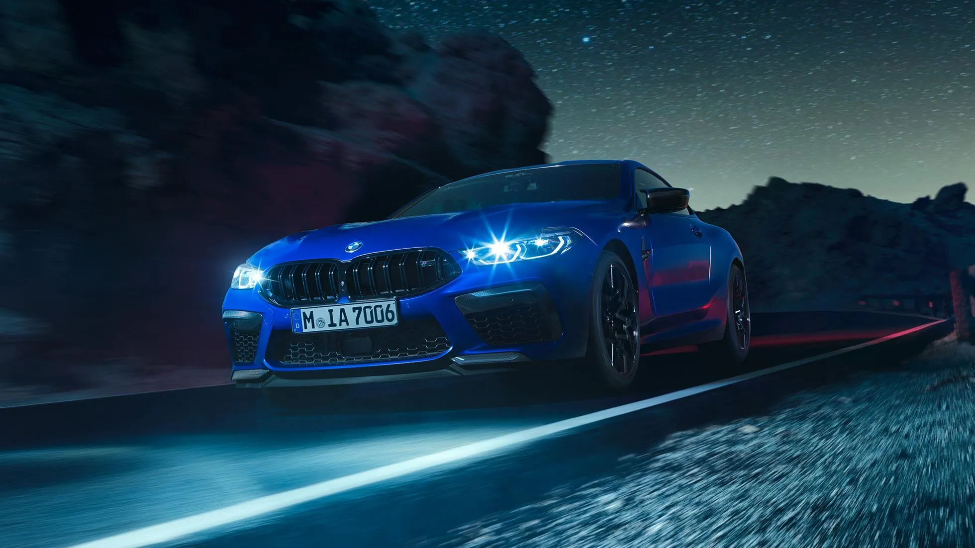 Powerful Blue Bmw Driving at Night on Mountain Road