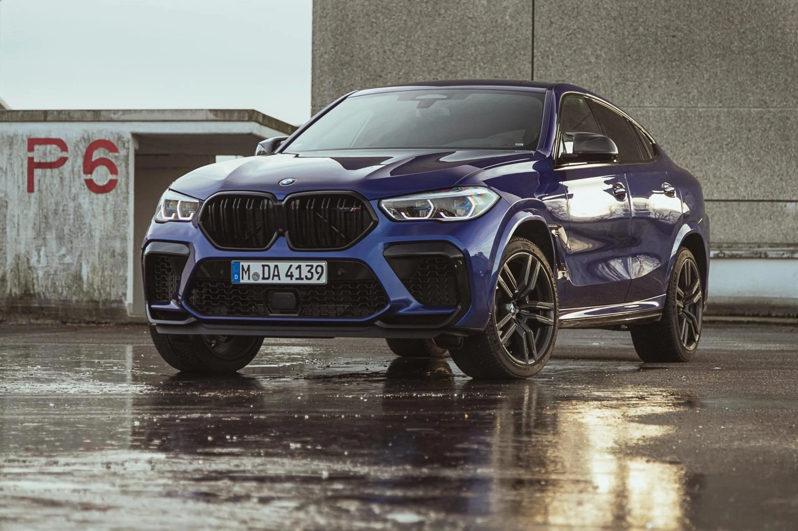 Powerful Blue Bmw Suv Parked on Wet Urban Pavement