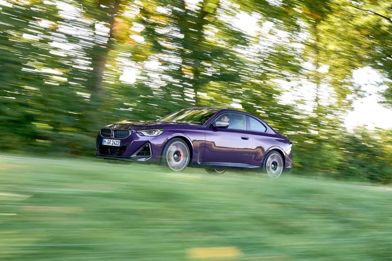 Purple Bmw Car Moving Fast Through Forest Area Wallpaper