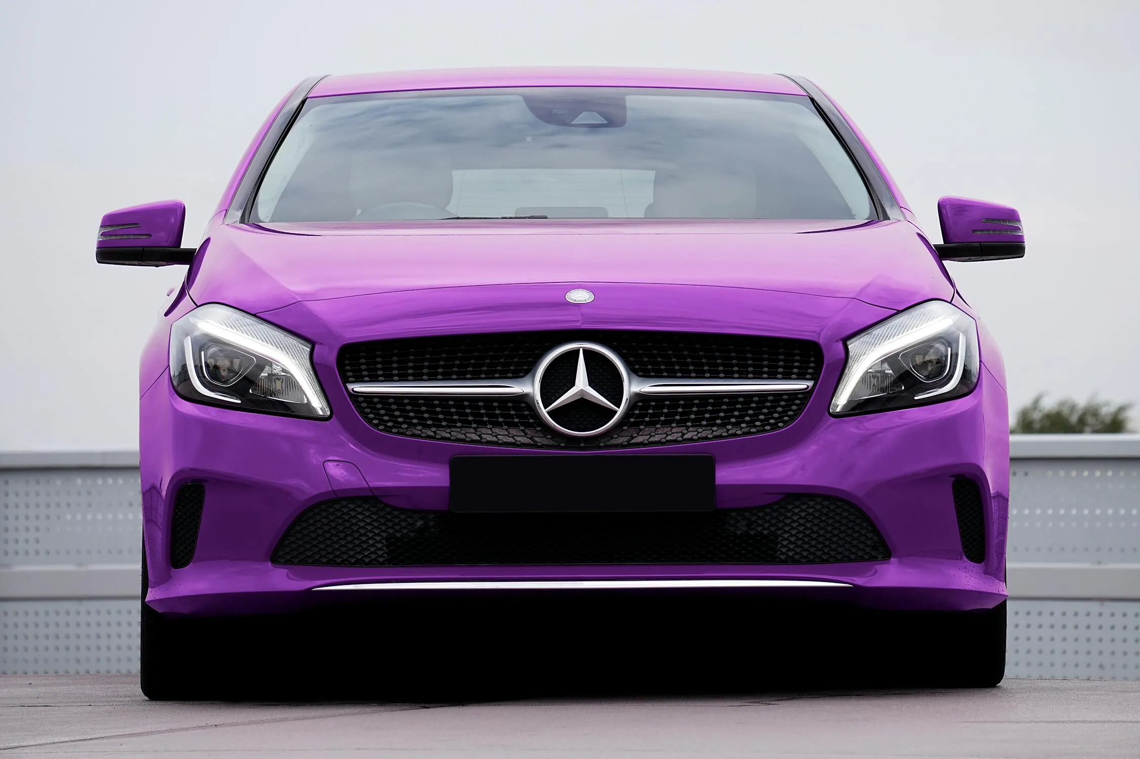 Purple Mercedes Benz Coupe Facing Front in Open Space