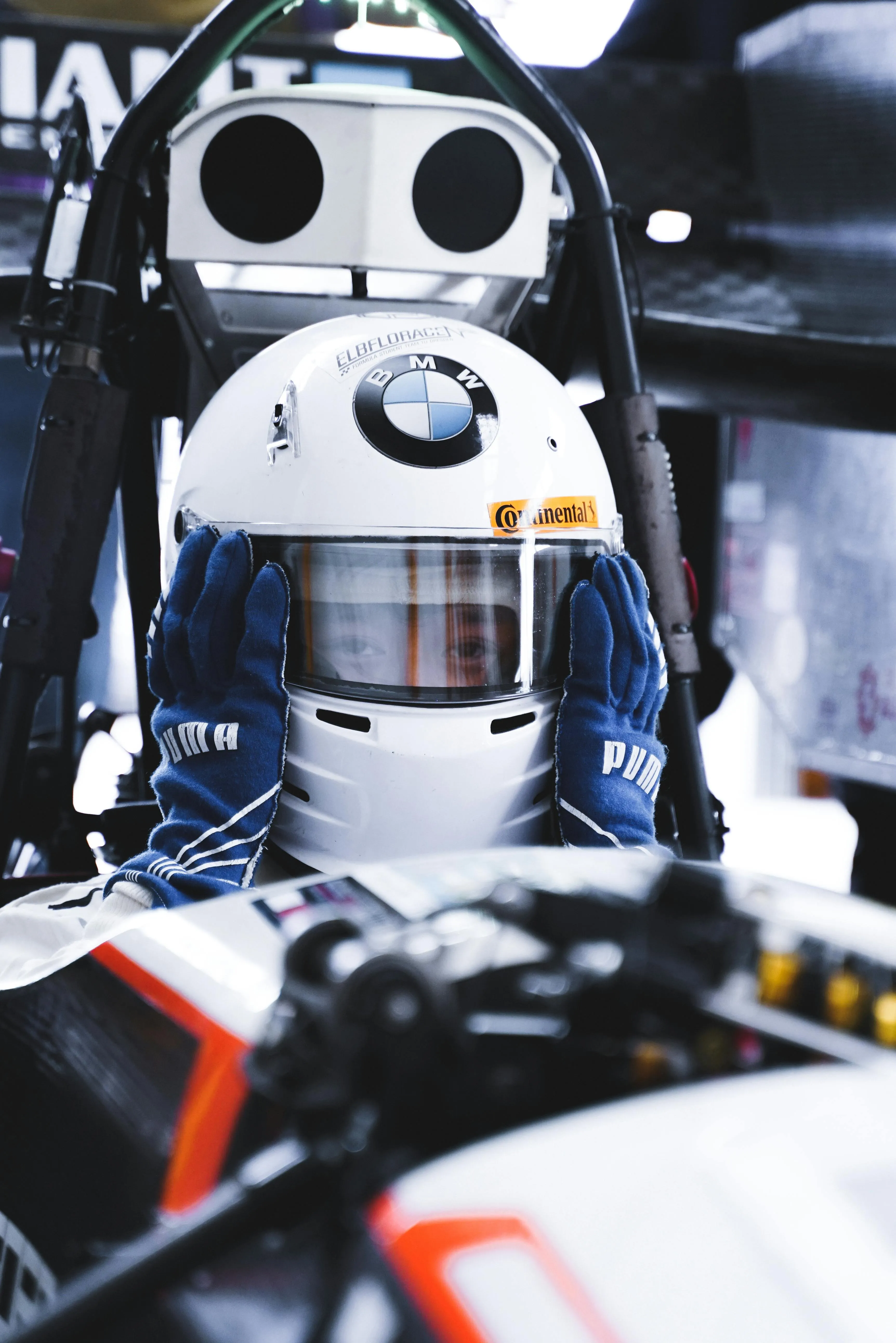 Race Driver in Cockpit Gear with Helmet and Race Suit