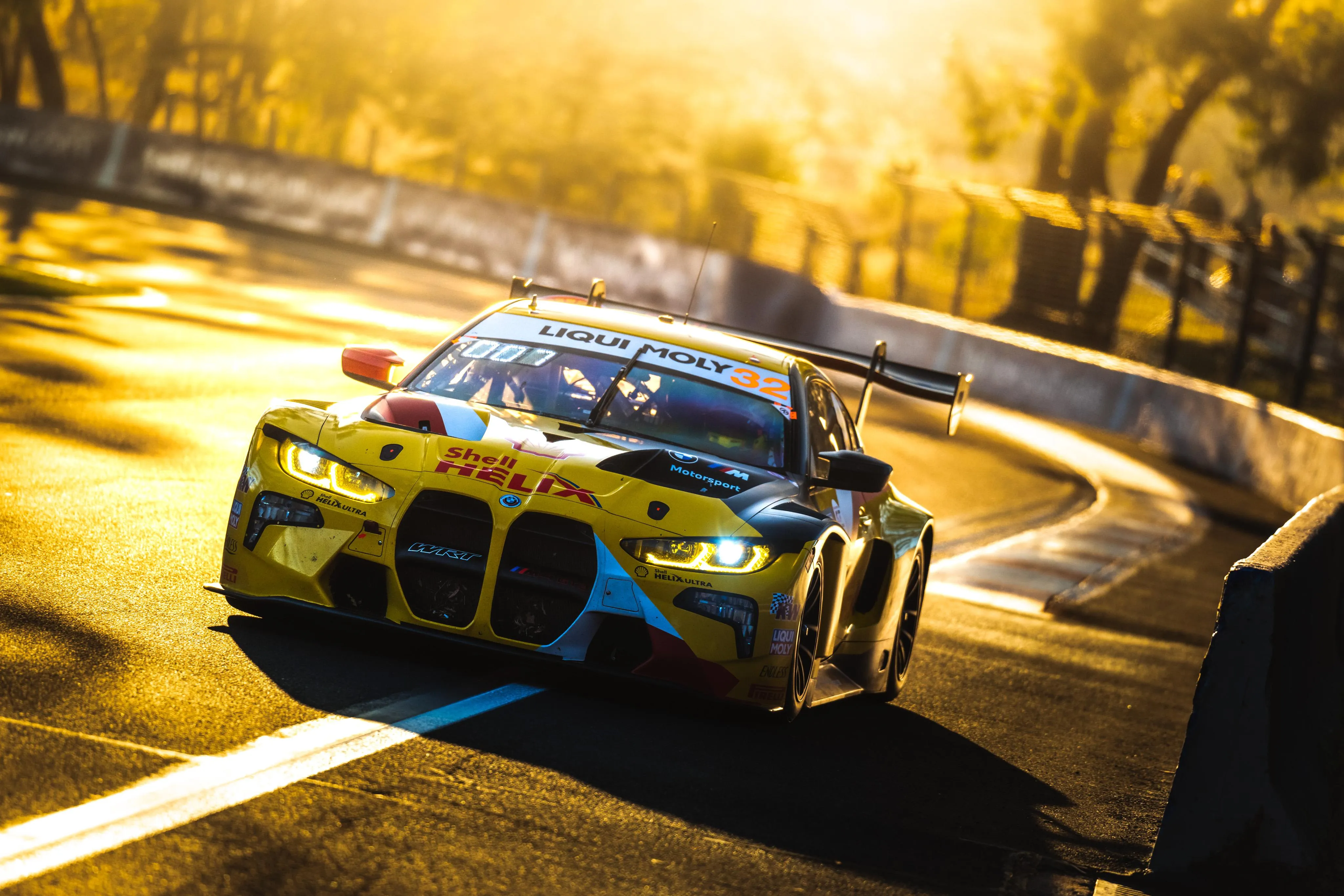 Racing Bmw Car Driving on Track During Golden Sunset