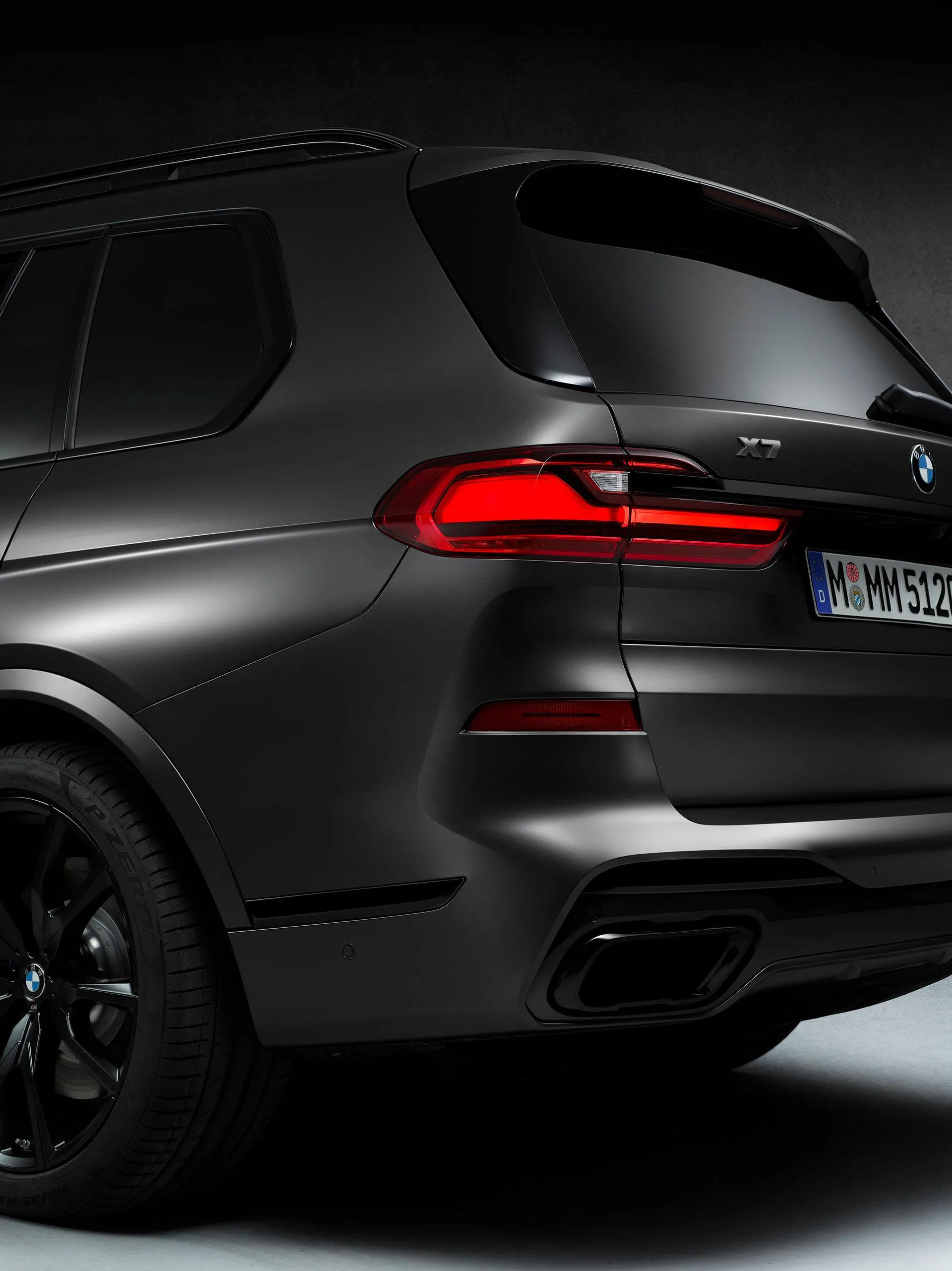 Rear Angle of a Black Bmw Suv Under Soft Ambient Lighting