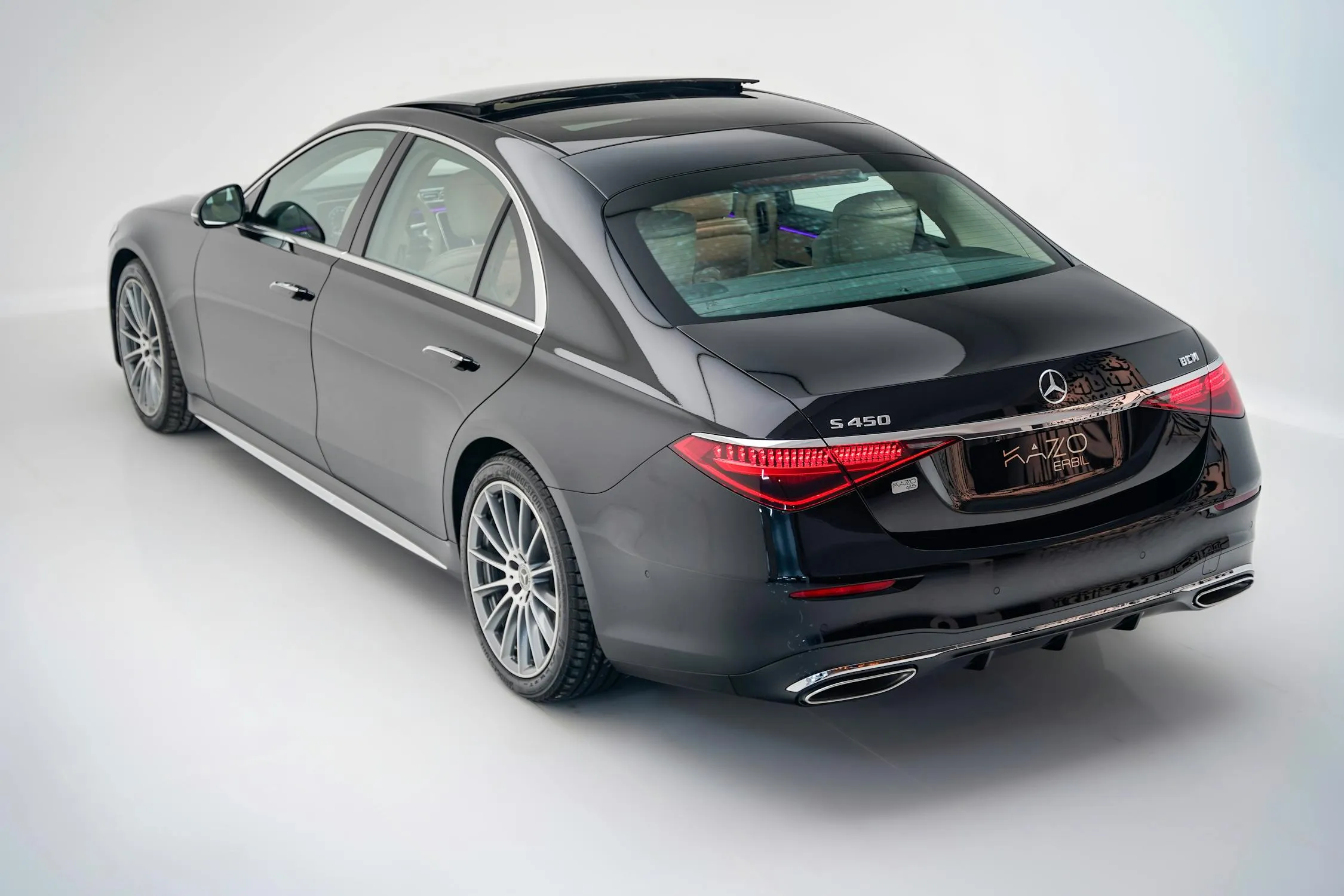 Rear Angle of Grey Mercedes Sedan in Studio Lighting