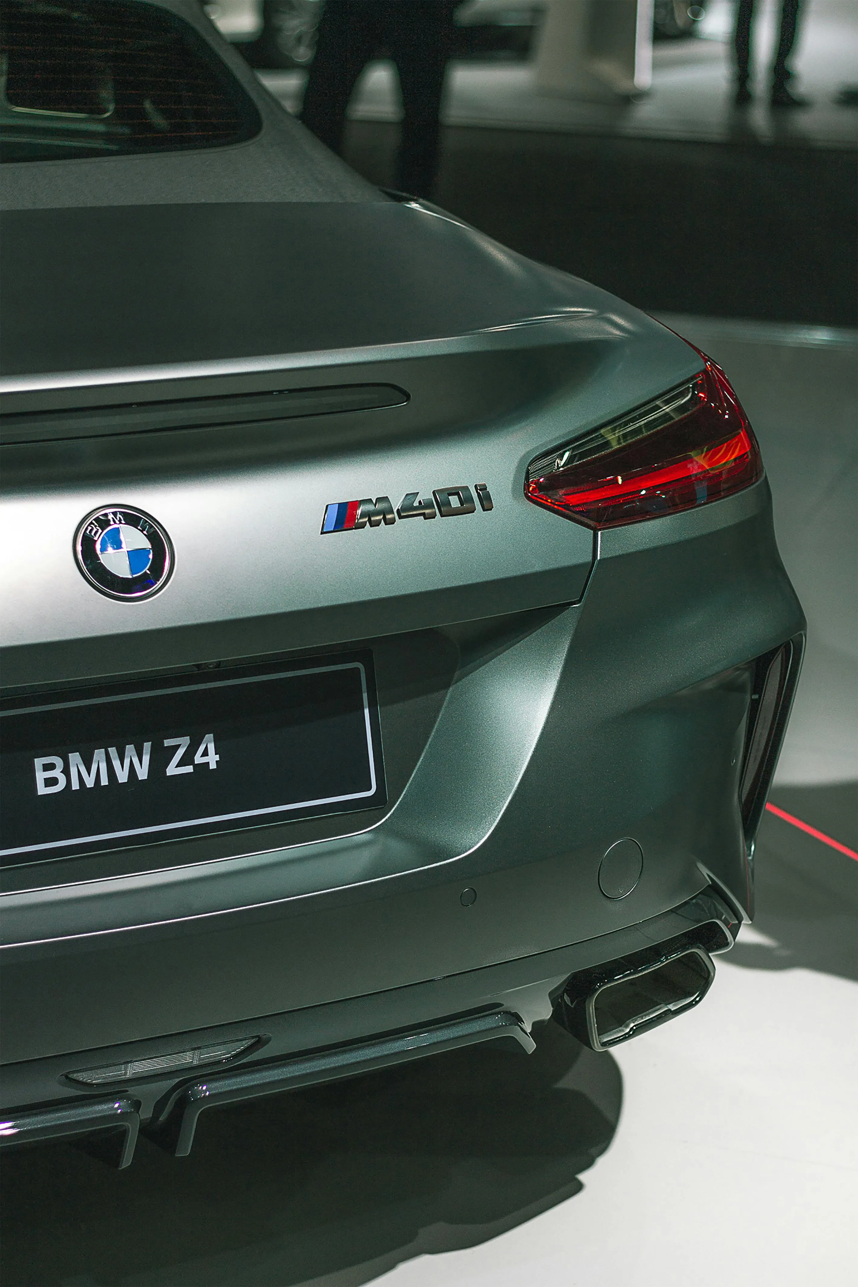 Rear Closeup of Bmw Z4 Badge and Taillight on Dark Car
