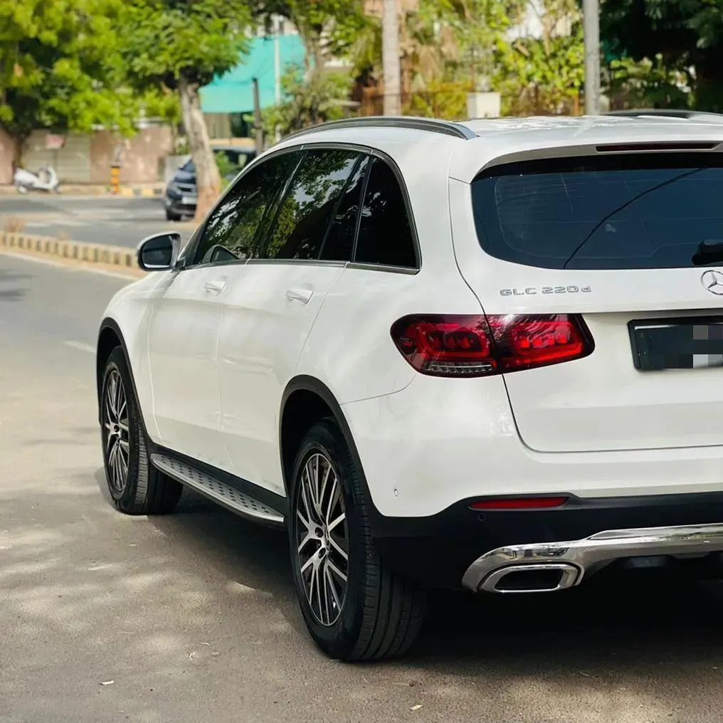 Rear Side View of White Mercedes Parked on Urban Road
